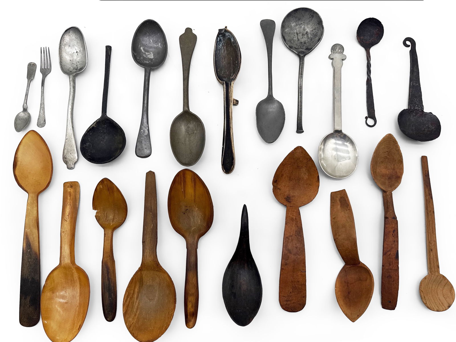 Primitive Bone, Wood, Pewter and Iron Spoons: A grouping of 18th and 19th C. spoons to include five carved bone spoons, five primitive wooden spoons, one spoon mold, five pieces of unmarked pewter, three pewter spoons with markings and three forg