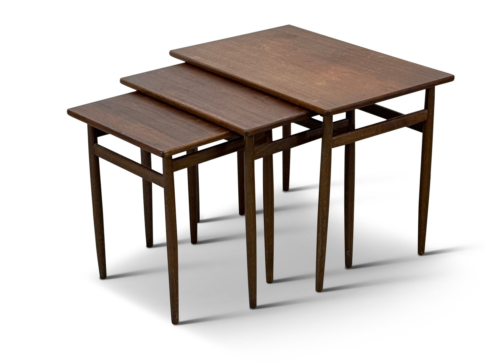 Nest of Three Danish Modern Tables: A nest of three Danish modern tables by Dux, raised on tapering legs. Largest: 19in tall x 24in wide x 16in deep. | You have additional shipping options! Philadelphia Metro area delivery, NYC curbside