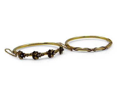 Pair of Art Nouveau 14K Bangle Bracelets: A pair of Art Nouveau 14K yellow gold hinged bangle bracelets, one accented with a floral pansy design with diamonds, the second rope wrapped. Both marked 14K. Both approx. 6-1/2in interior