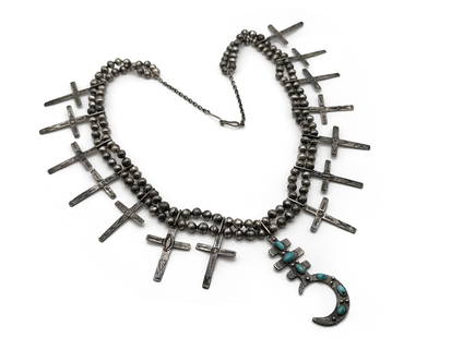 Native American Dragonfly Cross Necklace: A Native American silver necklace with a turquoise mounted dragonfly cross Naja and 14 bead drop crosses on a double bead necklace. Unmarked. 26-1/2in long. 73 dwt. | You have additional shipping