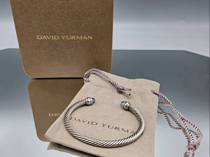 David Yurman Gold and Silver Cable Bracelet: A David Yurman 14K and sterling silver cable bracelet with faceted blue topaz ends. 5mm. 2-1/2in interior diameter. 19.1 dwt. | You have additional shipping options! Philadelphia Metro area delivery,