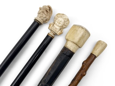 Four Canes with Carved Handles