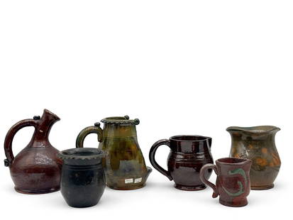 Six Stahl Pottery Vessels: To include a redware gooseneck handled jug, a thumbprint yellowware vase, a yellowware handled candlestick, two smaller redware pitchers, and a pinched-rim vase. Each piece is signed and dated. Smalle