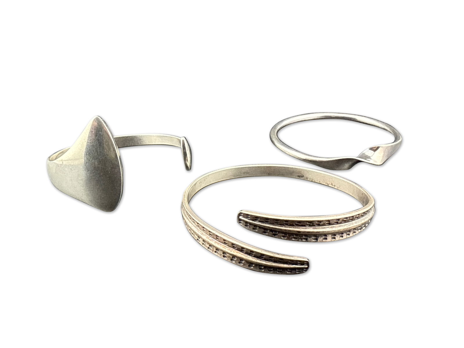 Three Scandinavian Silver Cuff Bracelets: A grouping of three Scandinavian silver cuff bracelets to include Hans Hansen, and two David Andersen, Norway. Largest: 8-3/4in interior circumference. | You have additional shipping options! Philadel