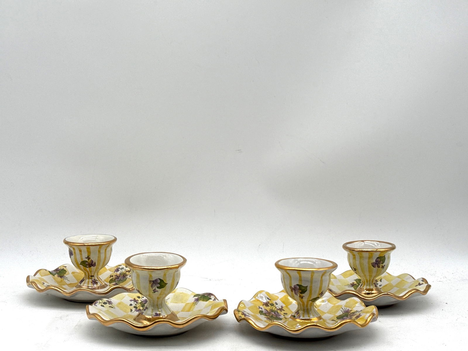 Four MacKenzie-Childs Lemon Curd Egg Cups: Four Victoria and Richard MacKenzie-Childs Lemon Curd egg cups with yellow grid pattern. Each impressed on bottom. 3in tall x 5in wide. | You have additional shipping options, and are not required to