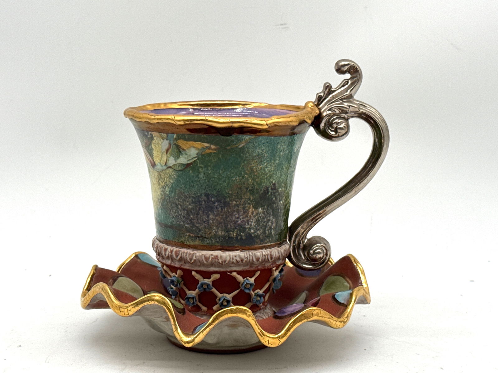 MacKenzie-Childs Evervolving Cocoa Mug & Saucer: A MacKenzie-Childs Evervolving cocoa mug and saucer. Mug: 6in tall x 6-1/2in wide. | You have additional shipping options, and are not required to use Live Shipping. Additional third-party shipper det