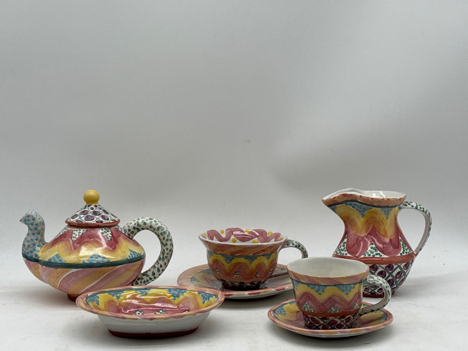 MacKenzie-Childs Keukenhof Ceramic Tea Set: A MacKenzie-Childs Keukenhof ceramic tea set comprised of a teapot, cream pitcher, bowl, and two cups and saucers. Teapot: 5in tall x 5in wide. | You have additional shipping options, and are not requ