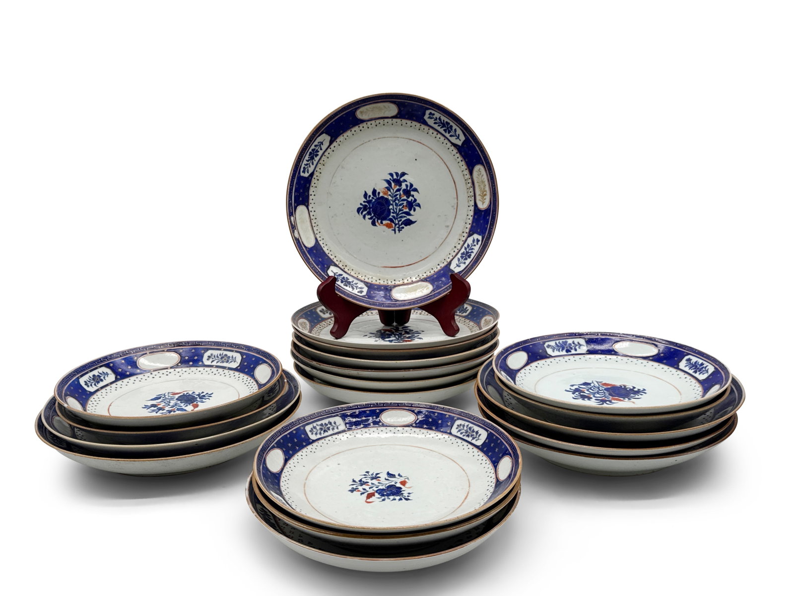 Grouping of Chinese Export Dishes: A grouping of 19 Chinese export dishes with floral spray centers and blue floral and gilt borders. Provenance: From the home of the late Helen E. Scott on the Ardrossan estate in Villanova, PA. Larges