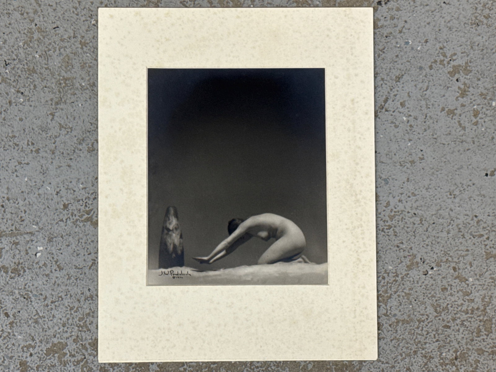 James Ponderlick Silver Gelatin Photograph: James G. Pondelicek (Czech/American, 20th C.). A silver gelatin print of a female nude worshiping a statue. Signed and dated 1920 lower left. 9in x 7in. | You have additional shipping options, and are