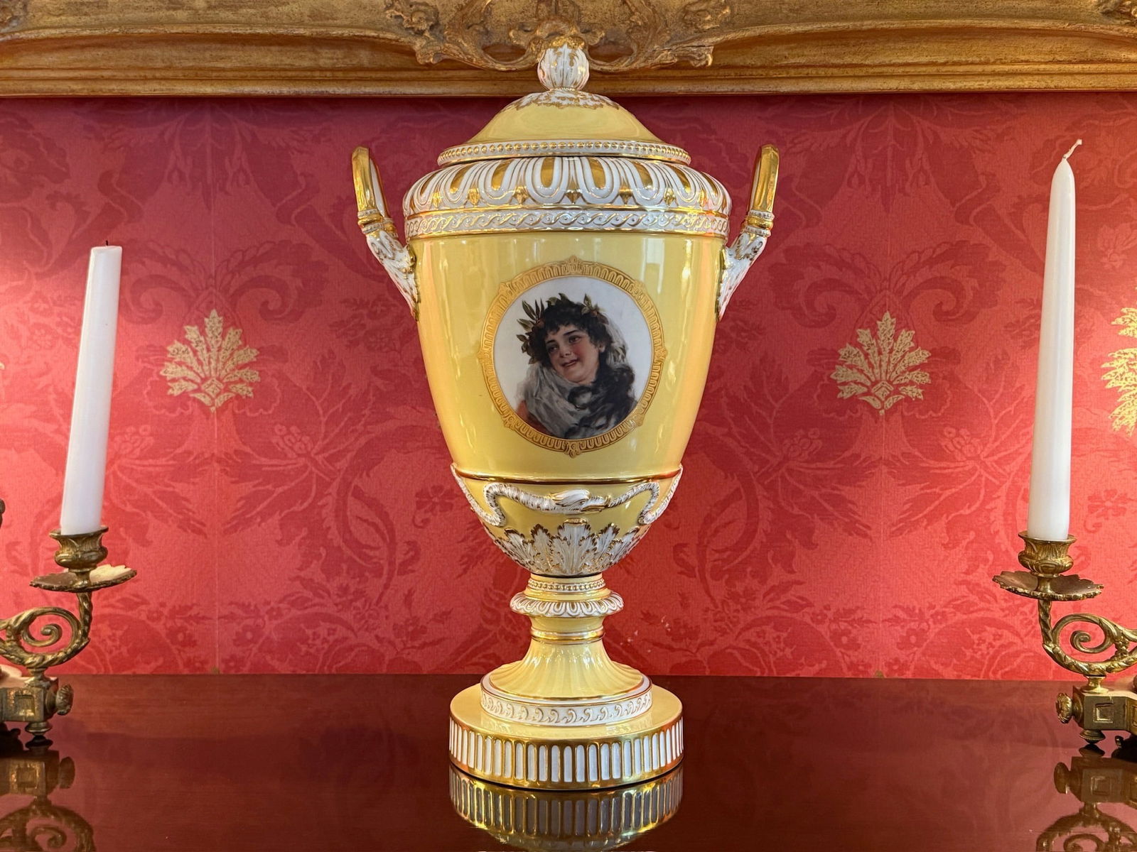 KPM Weimar Decorated Porcelain Vase: A KPM Weimar porcelain two-handled and lidded vase with yellow background, hand-painted woman, acanthus leaves, and wrapped snake motifs. Marked "KPM". Includes original Bailey, Banks, & Biddle sticke