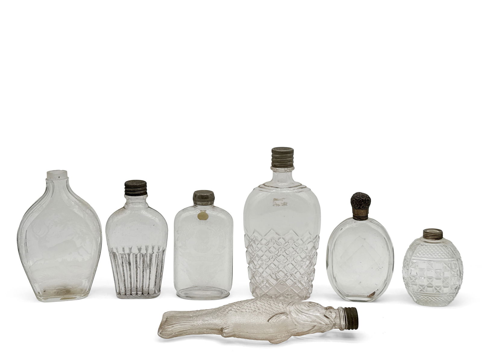 Seven 19th C. Glass Flasks: A grouping of seven 19th C. glass flasks, including a fish form. Largest: 8in tall x 4in wide. | You have additional shipping options, and are not required to use Live Shipping. Additional third-party