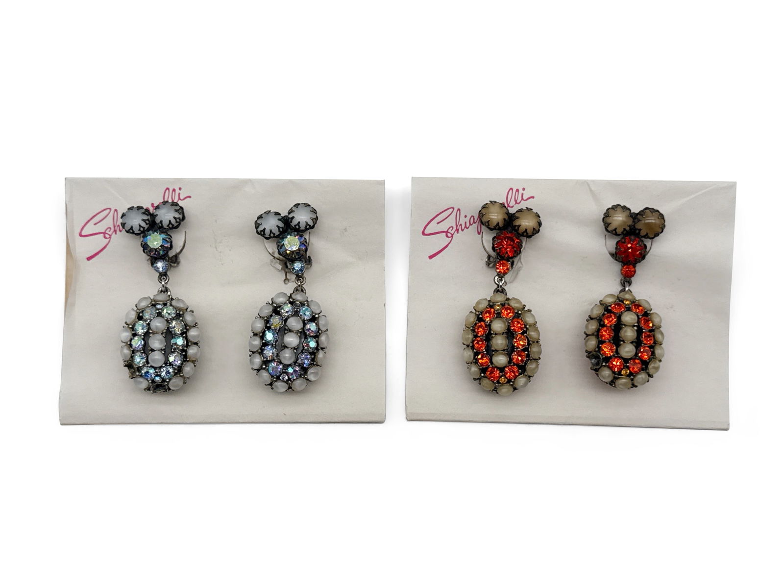 Two Schiaparelli Costume Drop Earrings: Two sets of vintage Schiaparelli costume earrings having rhinestone and pearlescent stones. Each marked. Original Schiaparelli cards. Earrings: 2-1/2 in tall x 1 in wide. | You have additional shippin