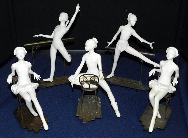 Lot of Five Boehm Ballerinas: Five porcelain Boehm ballerina figurines: Facing forward on chair; Sitting backwards on chair; Standing with straight lifted leg; Standing with bent lifted leg. Chairs, bars and floors are metal. 7" t