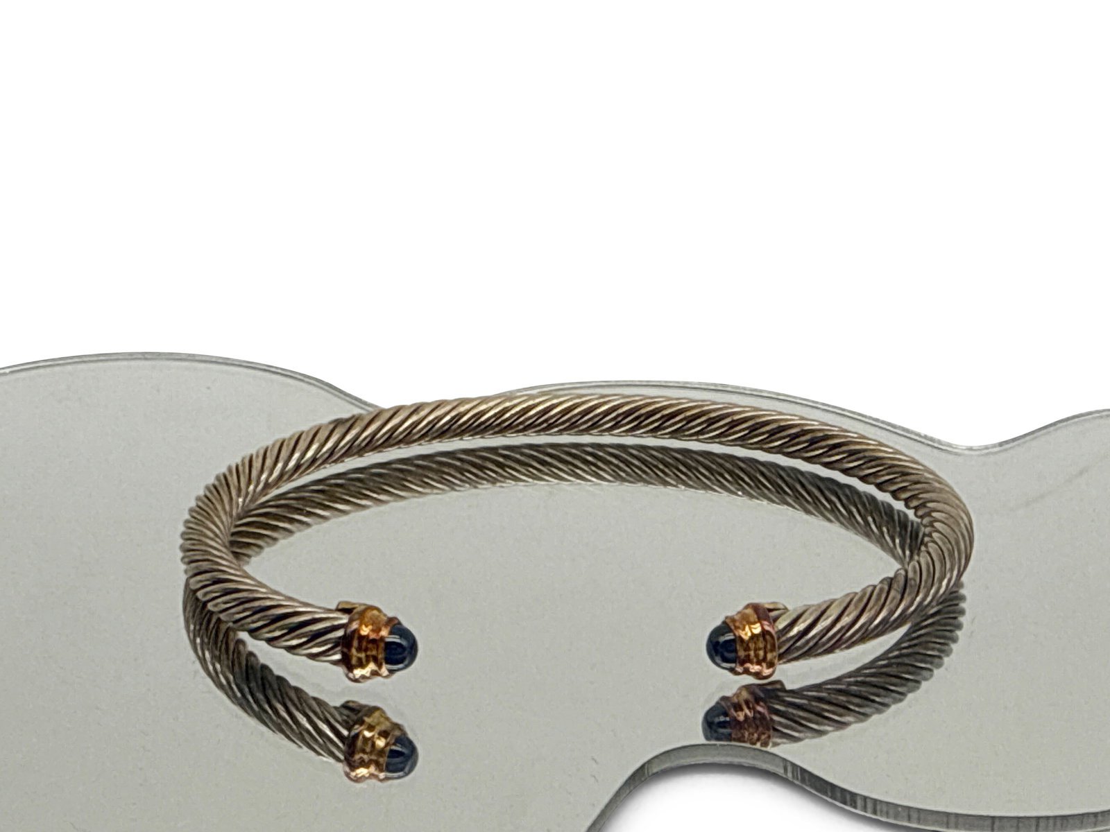 David Yurman Sterling and 14K Cable Bracelet: A David Yurman sterling silver cable bracelet with 14K yellow gold and gemstone tips. Stamped D.Y. .925 and 750. 10.3 dwt. 2-1/2in wide. | You have additional shipping options, and are not required to