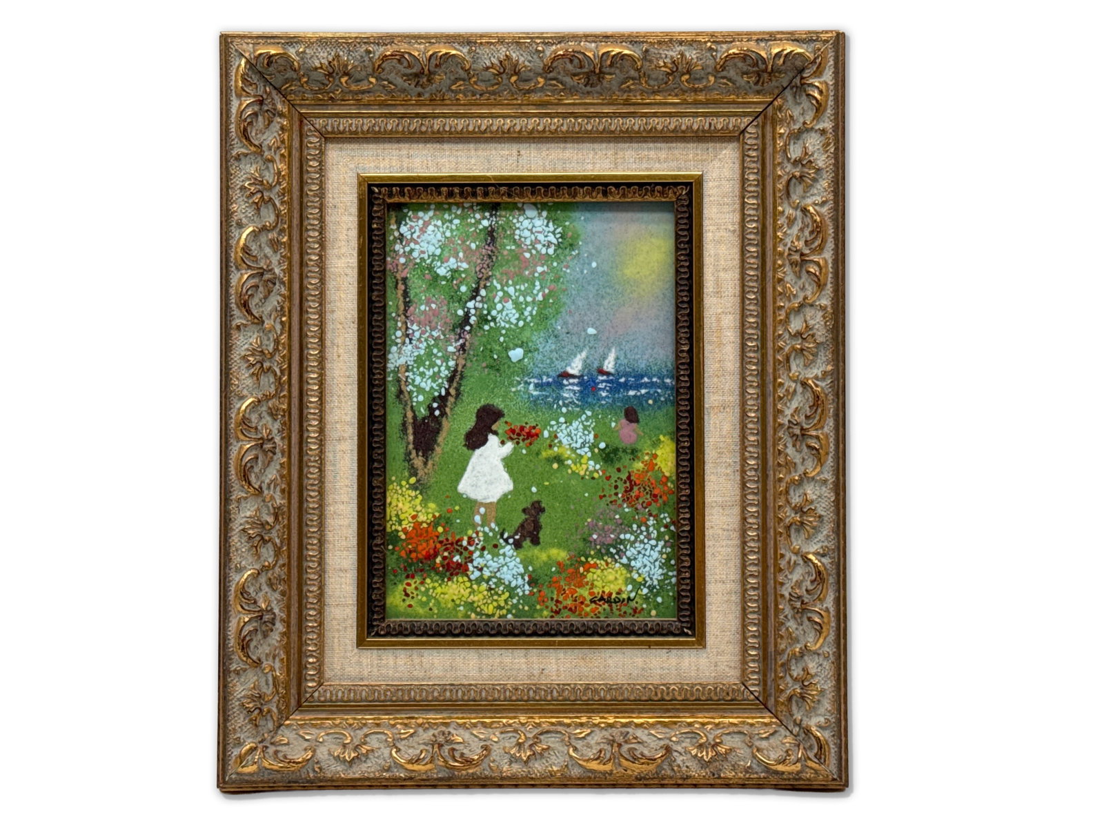 Louis Cardin Enamel/Copper: Playmates: Louis Cardin (French, b. 1931). An enamel painting on copper of young children playing in a flower field by a seaside with two sailboats. Titled "Playmates". Signed. Frame opening: 6-1/2in x 4in.