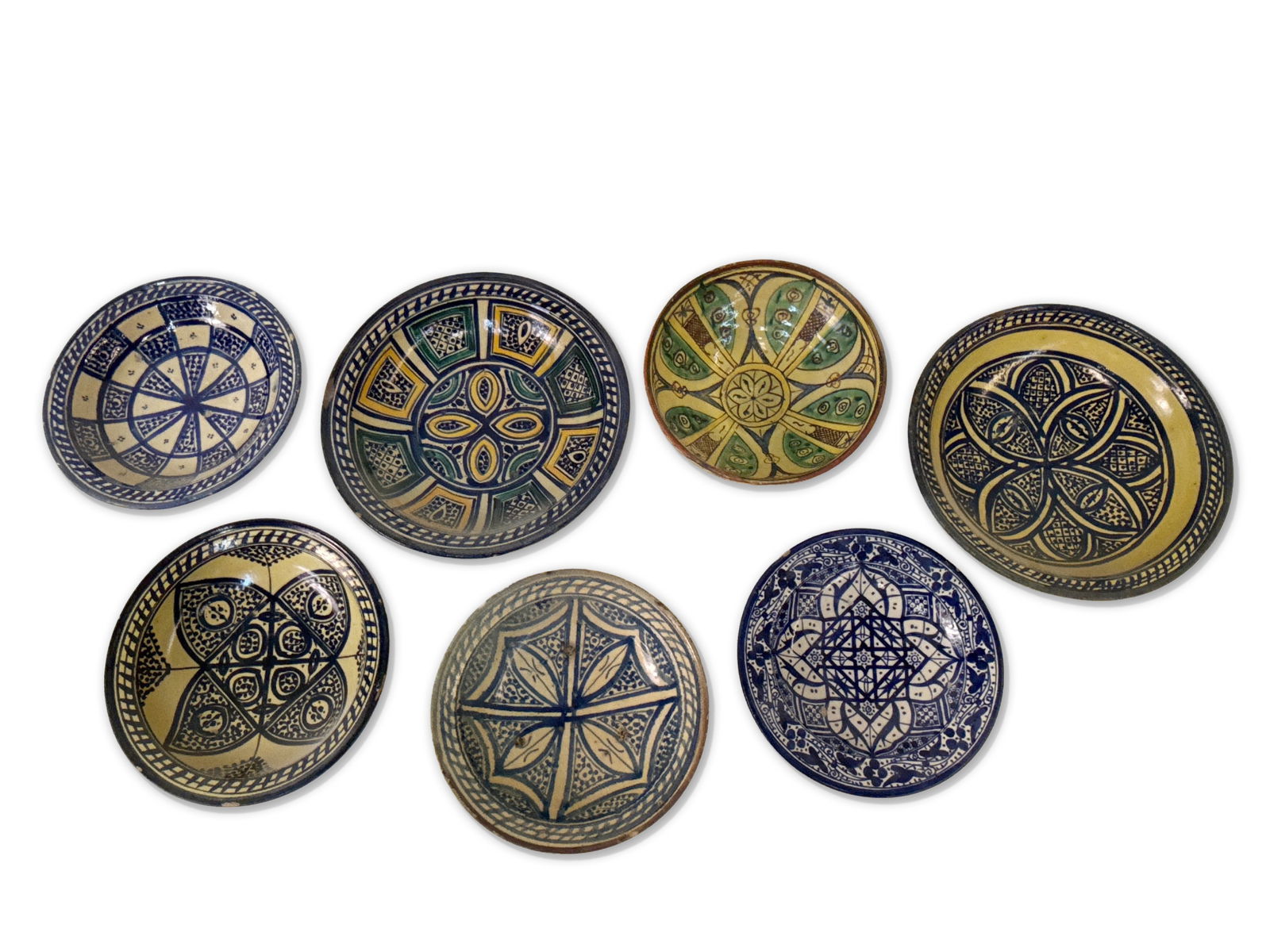 Seven Moroccan Slip-Painted Pottery Bowls: A grouping of seven Moroccan slip-painted earthenware pottery bowls with vibrant decoration. Provenance: From the collection of Dr. John Shea of Philadelphia, PA. Largest: 13-1/2in diameter. | You