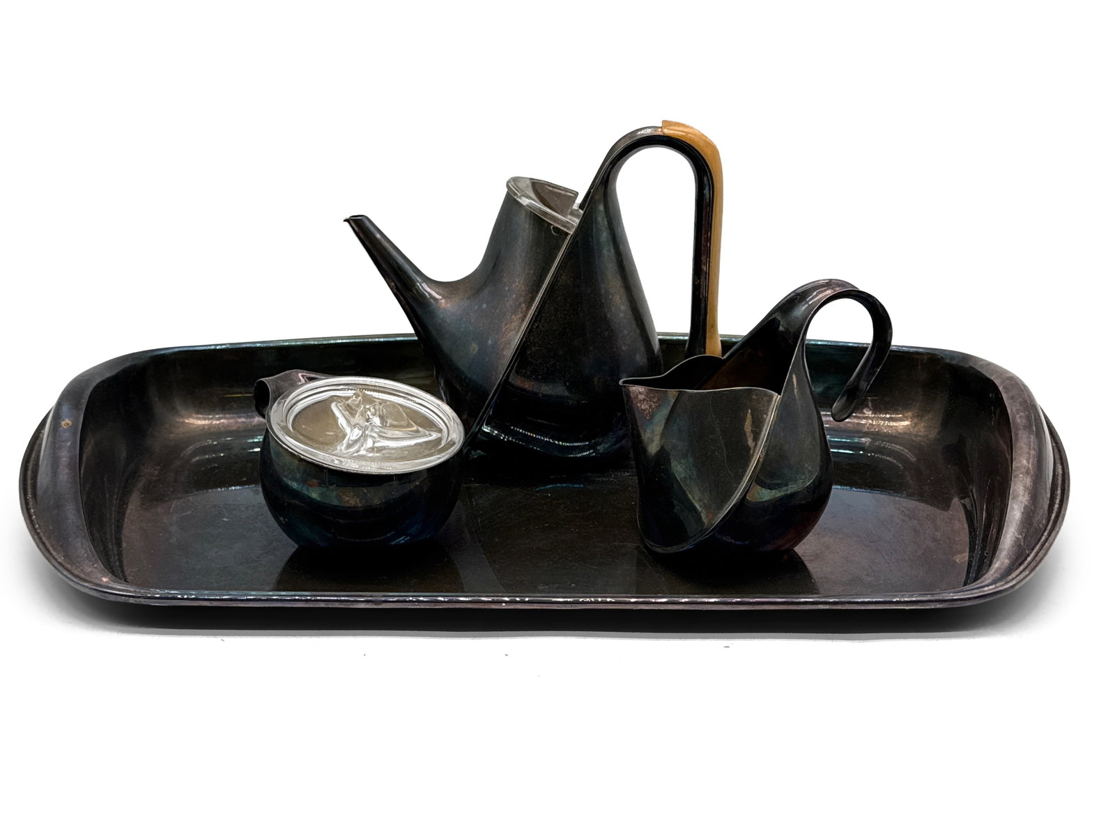 Tousquet Oscar For Alessi Tea Set: A four-piece Tousquet Oscar for Alessi modernist silver plate tea set in the "Oronda" pattern comprised of a teapot, sugar, creamer, and tray. Tray appears to be unmarked. Provenance: From the