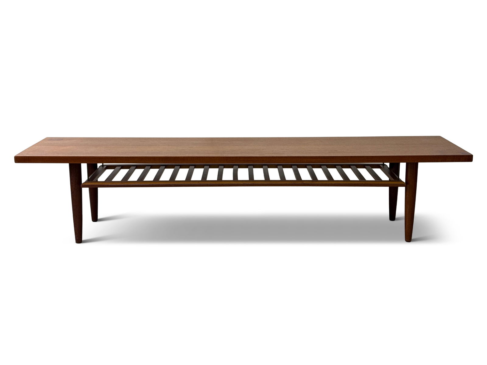 Nils Jonsson Teak Coffee Table: A Nils Jonsson Swedish modern teak coffee table for Troeds, Model Domi 27. 16-1/2in tall x 79in wide x 20-1/2in deep. | You have additional shipping options, and are not required to use Live Shipping.