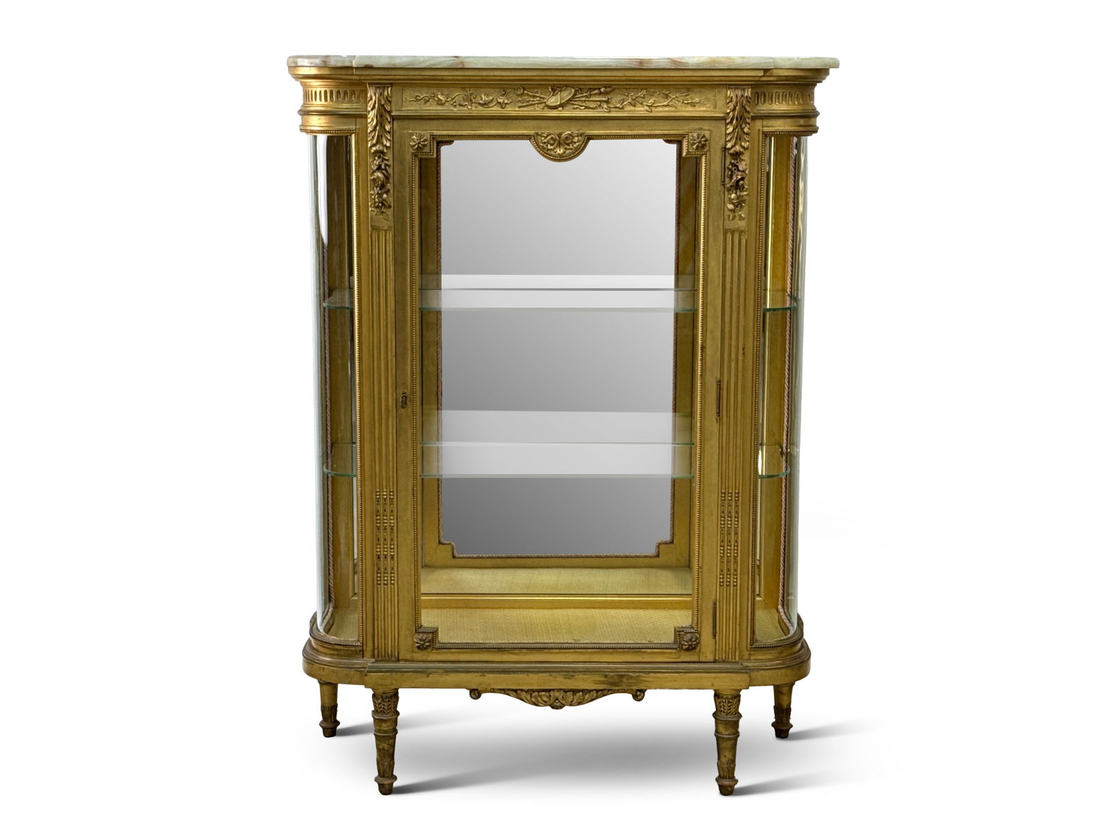 French Louis XVI-style Giltwood Vitrine Cabinet: A French Louis XV-style giltwood vitrine curio cabinet with an onyx top, mirrored back, and glass shelves, raised on turned legs. 52-1/4in tall x 39in wide x 15in deep. | You have additional shipping