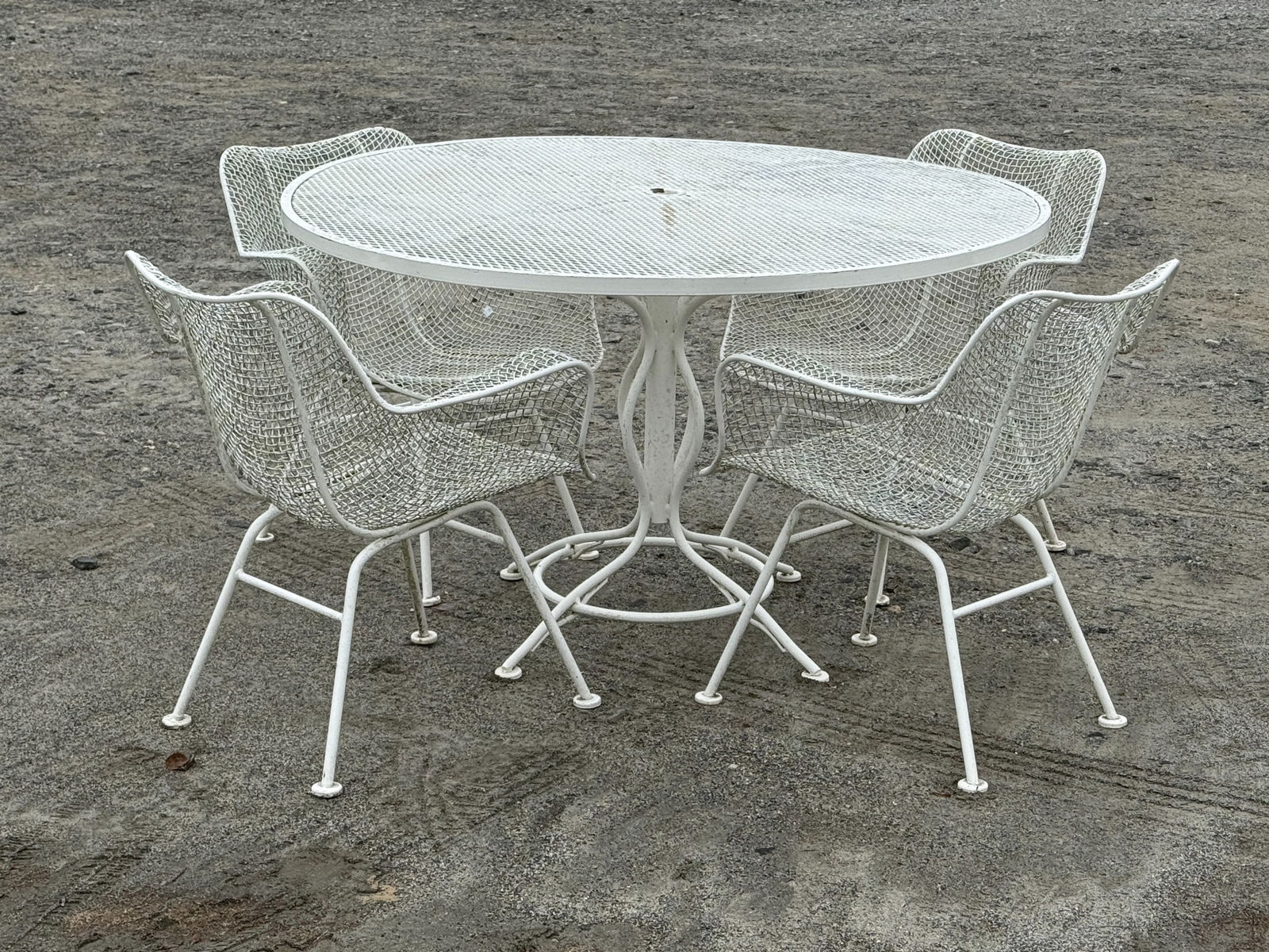 Russell Woodard Sculptura Patio Dining Set: A Russell Woodard Sculptura patio dining set comprised of a dining table and four mesh armchairs. Table: 30in tall x 47in wide. | You have additional shipping options, and are not required to use