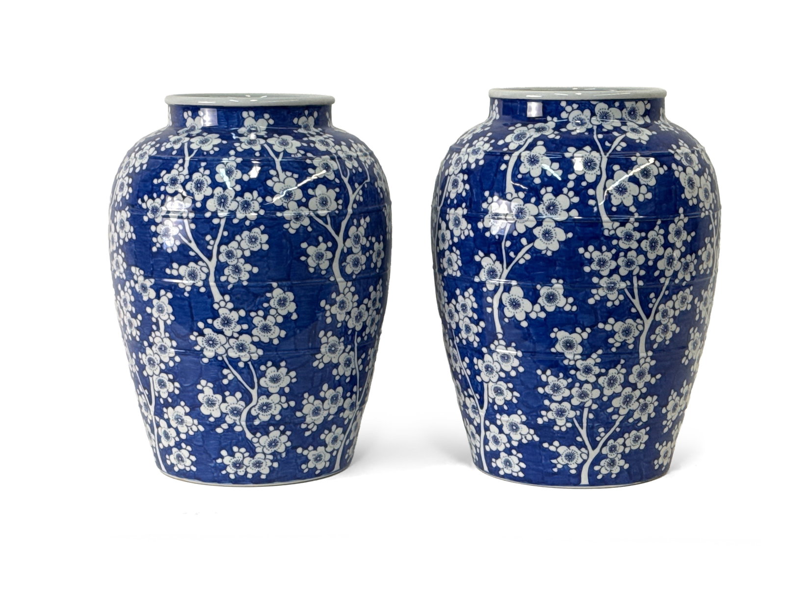 Pr. Chinese Blue and White Cherry Blossom Vases: A large pair of Chinese blue and white porcelain jar vases with cherry blossom designs. Approx. 17-1/2in tall x 12-1/2in wide. | You have additional shipping options, and are not required to use Live