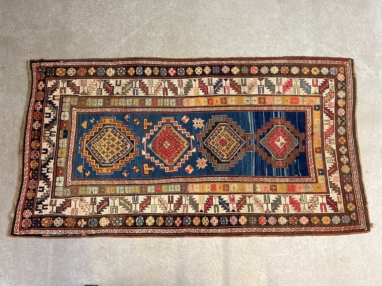 Caucasian Kazak Area Carpet, 8ft 1in x 4ft 6in: A hand-knotted antique Caucasian Kazak area carpet with diamond medallions. 8ft 1in x 4ft 6in. | You have additional shipping options, and are not required to use Live Shipping. Additional third-party