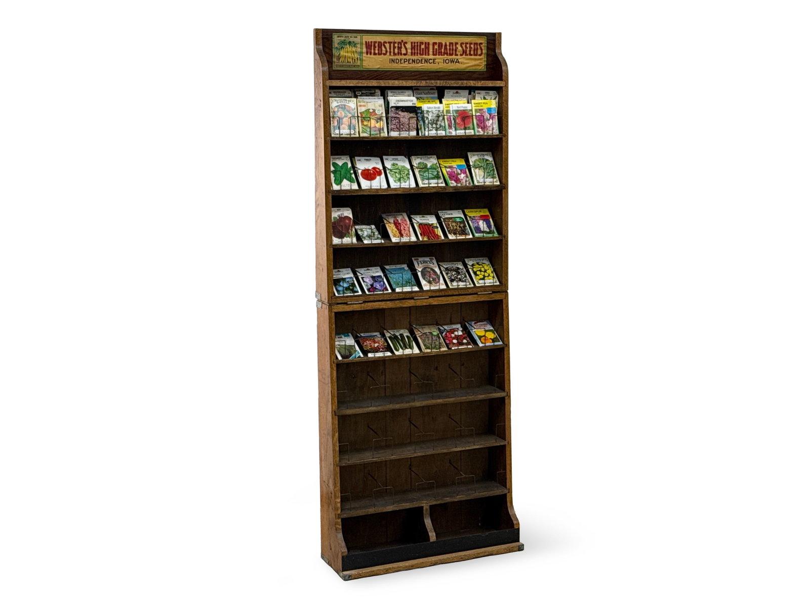 Webster's Folding Seed Packet Display: A Webster's "High Grade Seeds / Independence Iowa" folding seed packet display. Currently fitted as a standing display. 64-1/2in tall x 24in wide x 8-1/2in deep. | You have additional shipping
