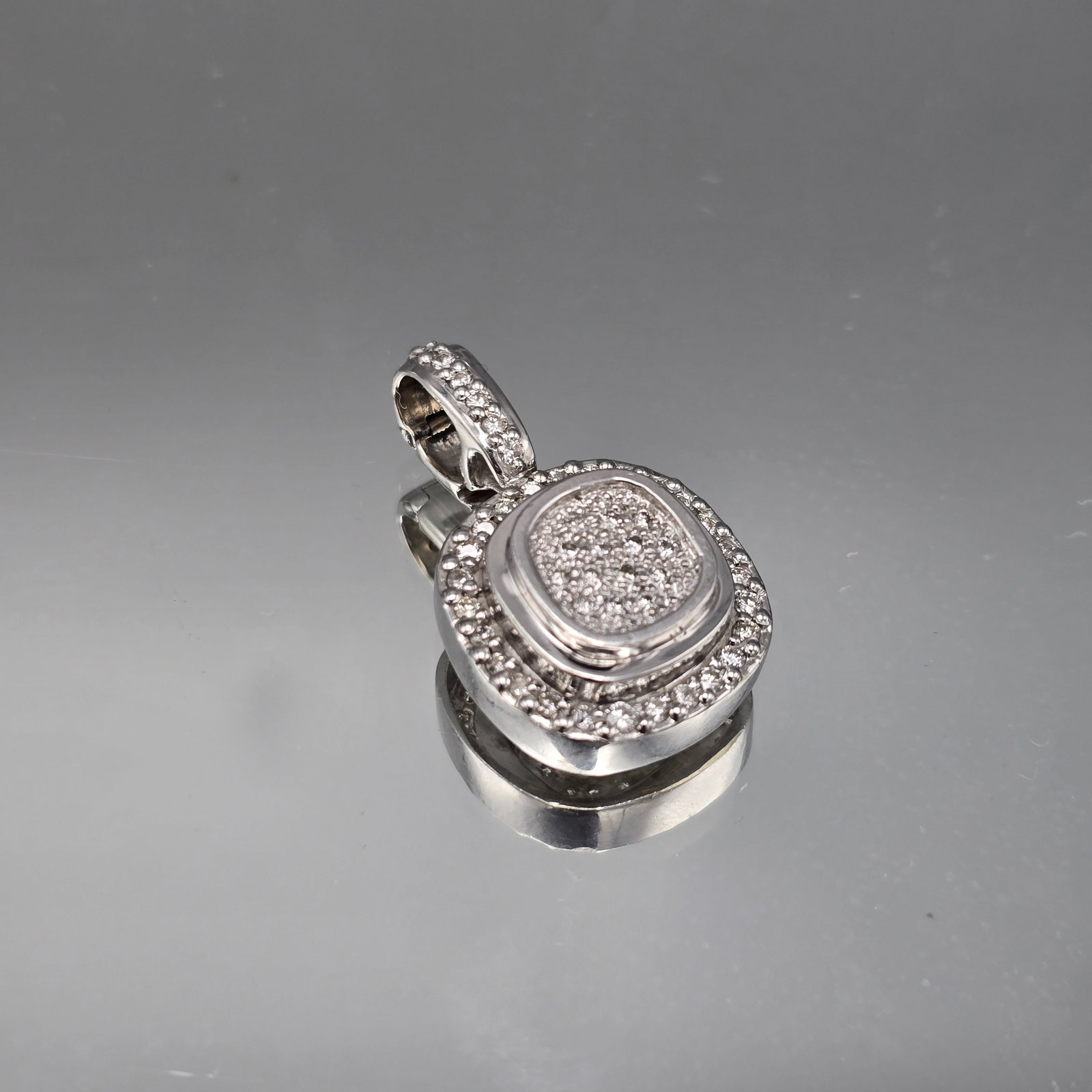 14K White Gold and Diamond Cushion Pendant: A 14K (tested) white gold and diamond cushion pendant. 1-1/4in x 3/4in. 6.04 dwt. | You have additional shipping options, and are not required to use Live Shipping. Additional third-party shipper