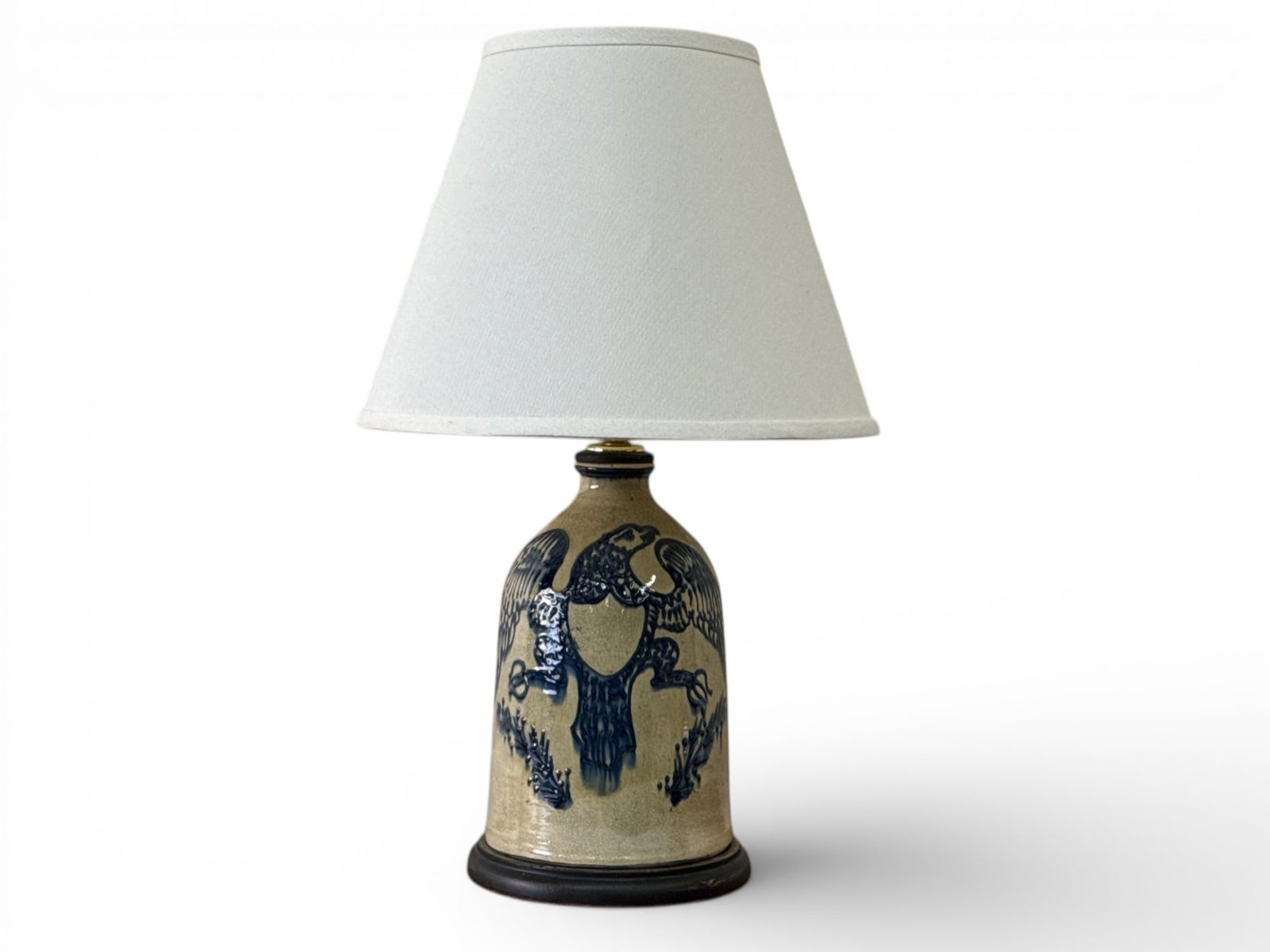 Turtlecreek Potters Stoneware Jug-Form Lamp: A Turtlecreek Potters stoneware jug-form table lamp with a Federal eagle decoration. Signed "Christopher Woods" and dated 2003. 22-1/2in tall. | You have additional shipping options, and are not