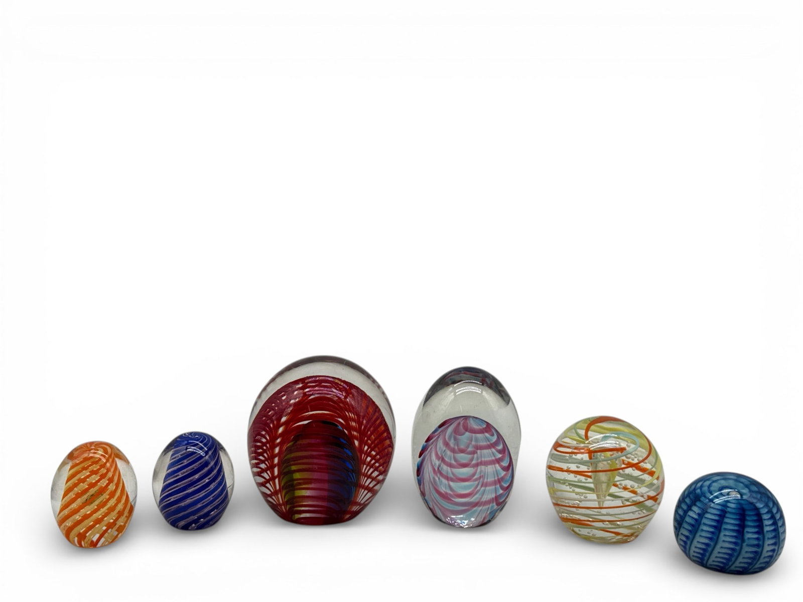 Six Italian Murano Swirled-Glass Paperweights: Six Italian Murano swirled- and pulled-glass paperweights to include two signed Roberto Moretti, and one signed Vitrix. Largest: 5in tall x 4in wide. | You have additional shipping options, and are
