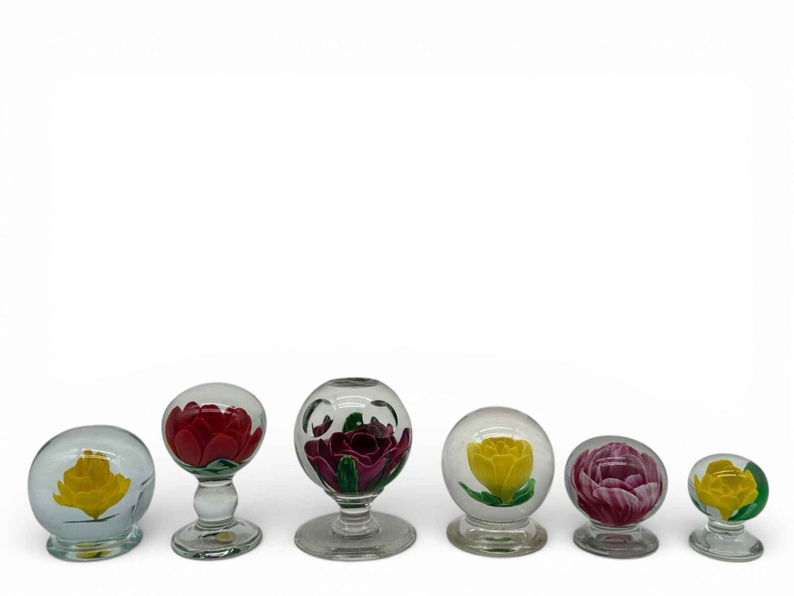 Six English Art Glass Paperweights: Six English Art glass footed paperweights with flower interiors. Four unsigned; one signed Kraft; one signed Band an England. Largest: 4in tall x 3in wide. | You have additional shipping options, and