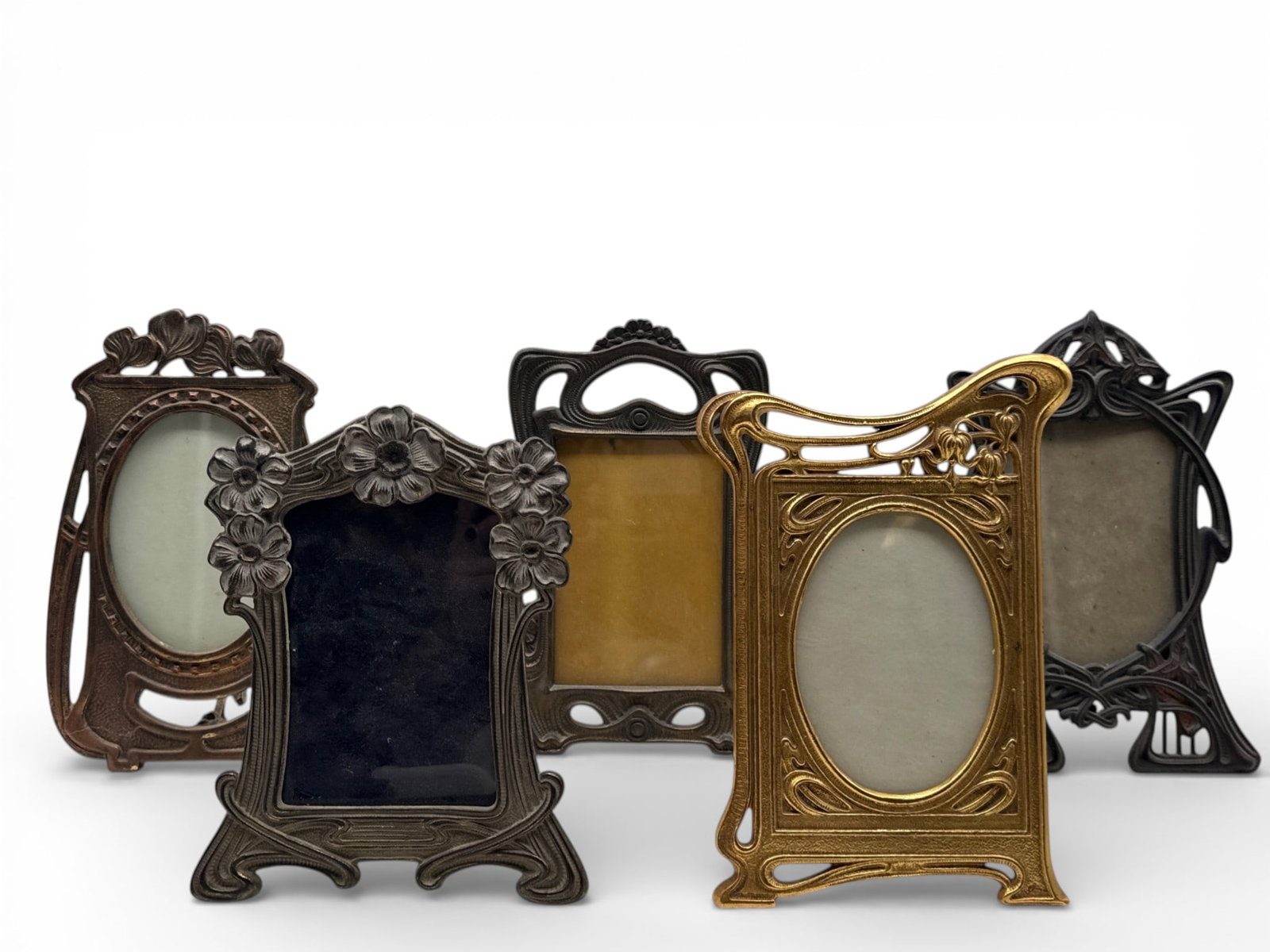 Five Art Nouveau Frames: A collection of five Art Nouveau brass and cast iron picture frames with stylized botanical decoration. Each has style number verso. Largest: 10in tall x 6in wide. | You have additional shipping optio