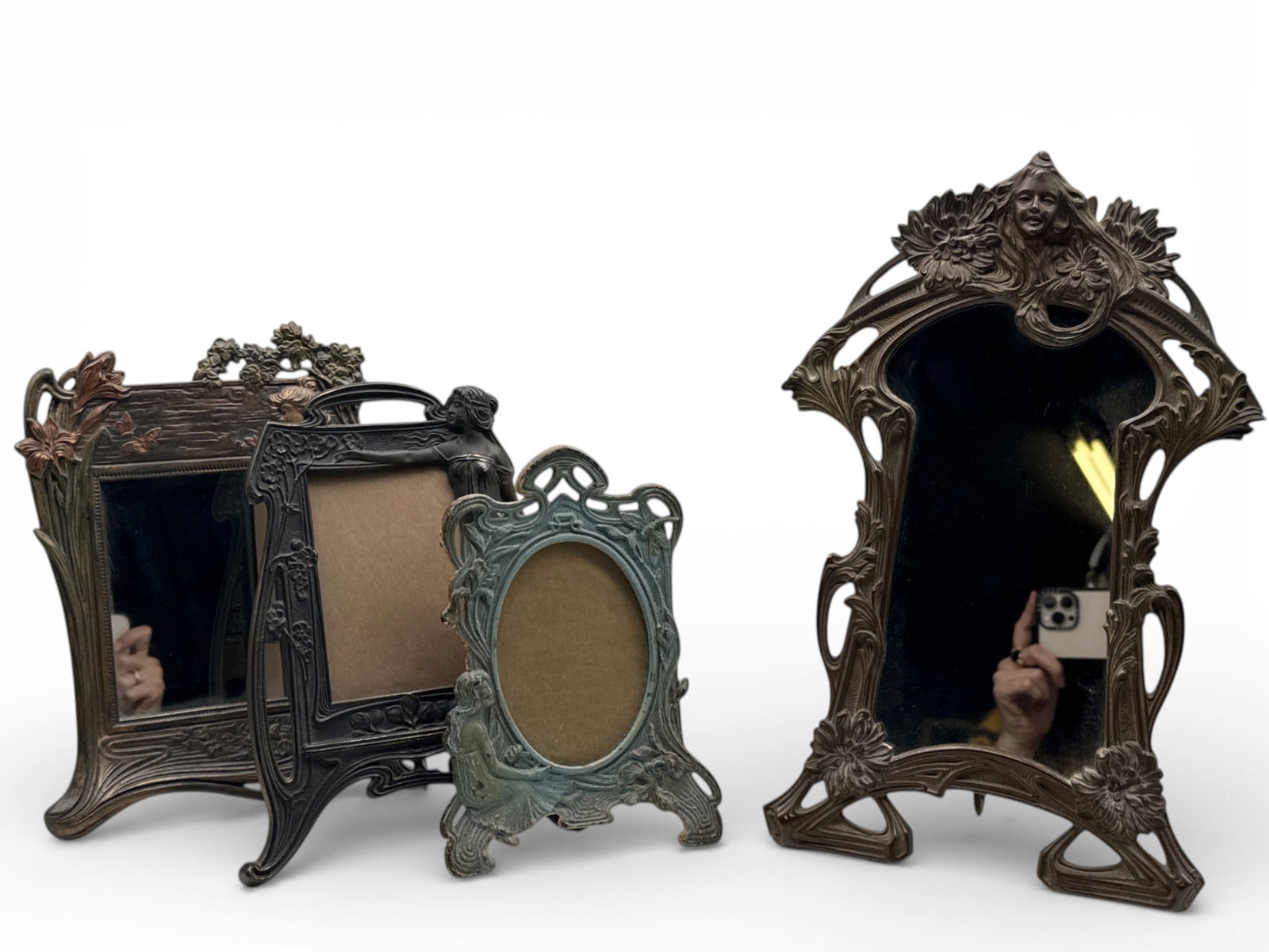 Art Nouveau Frames and Figural Mirror: Grouping of three Art Nouveau cast iron stylized picture frames, and an ornate figural mirror. Largest: 12in tall x 9in wide. | You have additional shipping options, and are not required to use Live S