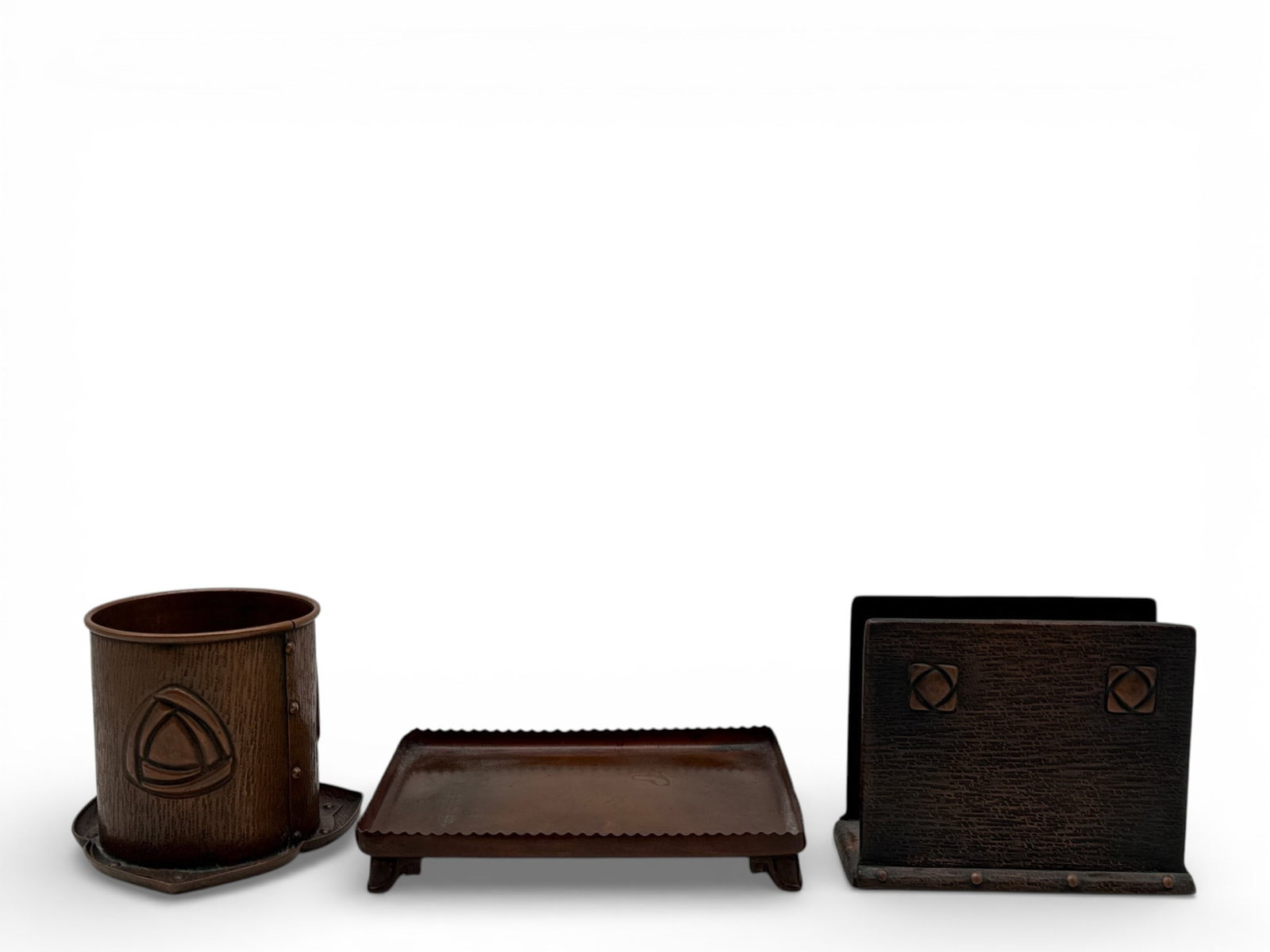 Arts & Crafts Copper Desk Suite: A collection of Arts & Crafts copper desk items to include a hammered copper cylindrical pen holder, a stylized letter holder, and a Gorham copper stationery tray with scalloped edges and Greek key sc