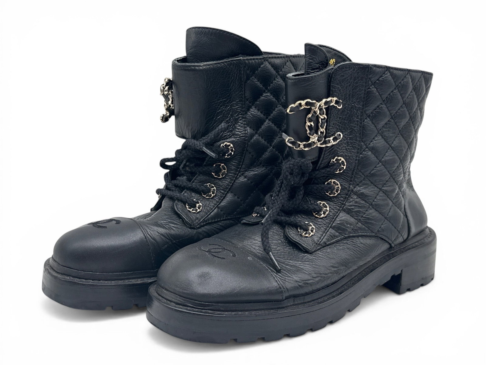 Chanel CC Quilted Leather Combat Boots: A pair of Chanel black quilted-leather combat boots with large CC monogram and chain closure at laces. Size 40. | You have additional shipping options, and are not required to use Live Shipping. Addit