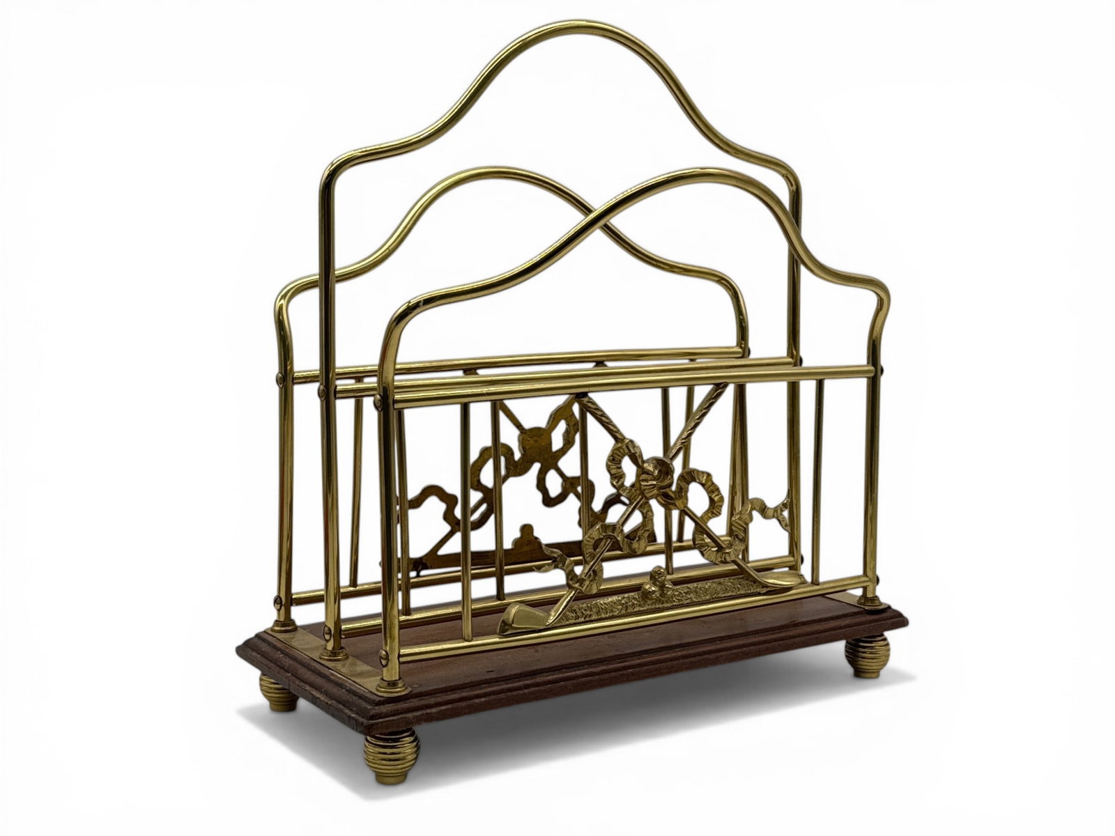 Edwardian Tubular Brass Canterbury: An Edwardian tubular brass canterbury with a golf club and ribbon motif raised on a mahogany base with brass ball feet. Base stamped "S. Hall". 14-1/2in tall x 14in wide x 8in deep. | You have additio