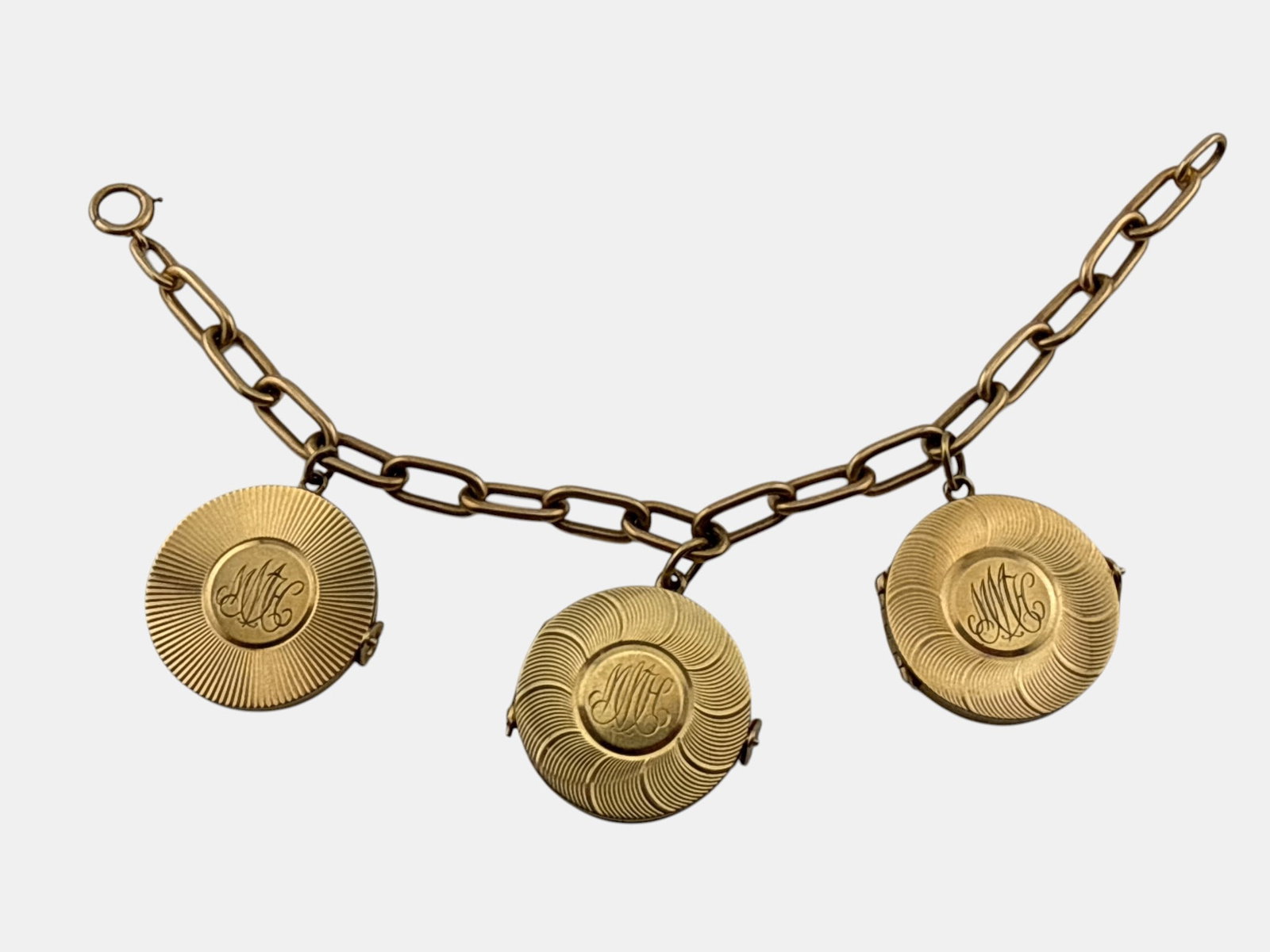 14K Yellow Gold Locket Charm Bracelet: A 14K yellow gold link bracelet with three hinged locket charms. Marked 14K. 7-1/4in long. 32.2 dwt. | You have additional shipping options, and are not required to use Live Shipping. Additional third