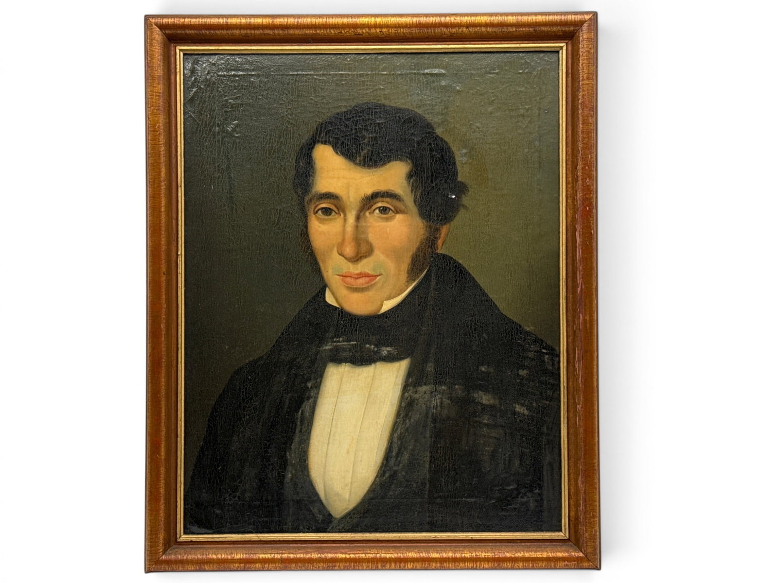 American Folk Art Portrait of a Gentleman: An American Folk Art oil on panel portrait of a gentleman in a black suit. Frame: 22in x 18-1/2in. | You have additional shipping options, and are not required to use Live Shipping. Additional shippin