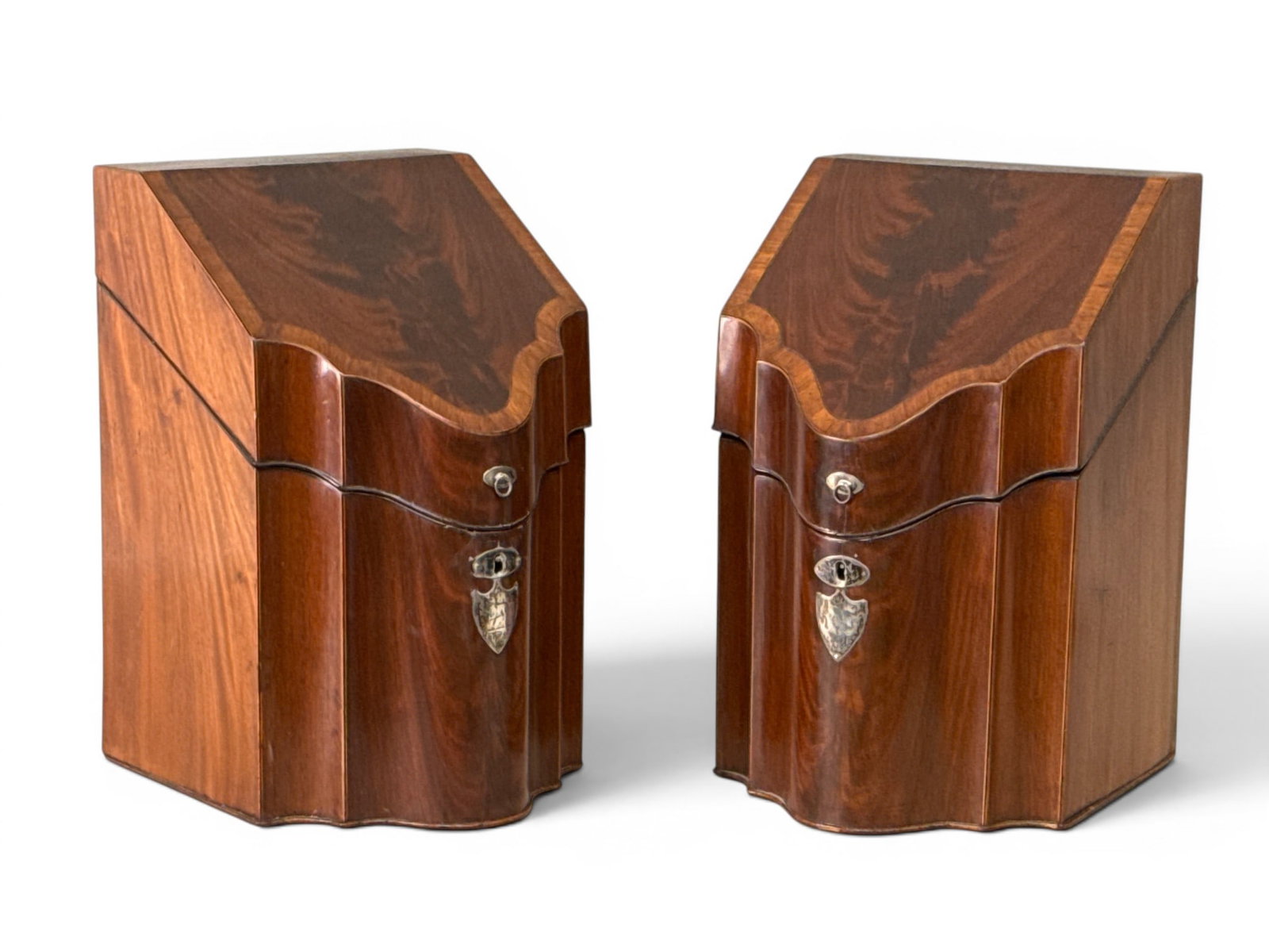 Pair of George III Mahogany Knife Boxes: A pair of English George III inlaid mahogany knife boxes of serpentine forms with fitted interiors. Provenance: From a Main Line, PA private collection. Ex: Thomas Schwenke, Inc. 14-1/2in tall x 9-1/4