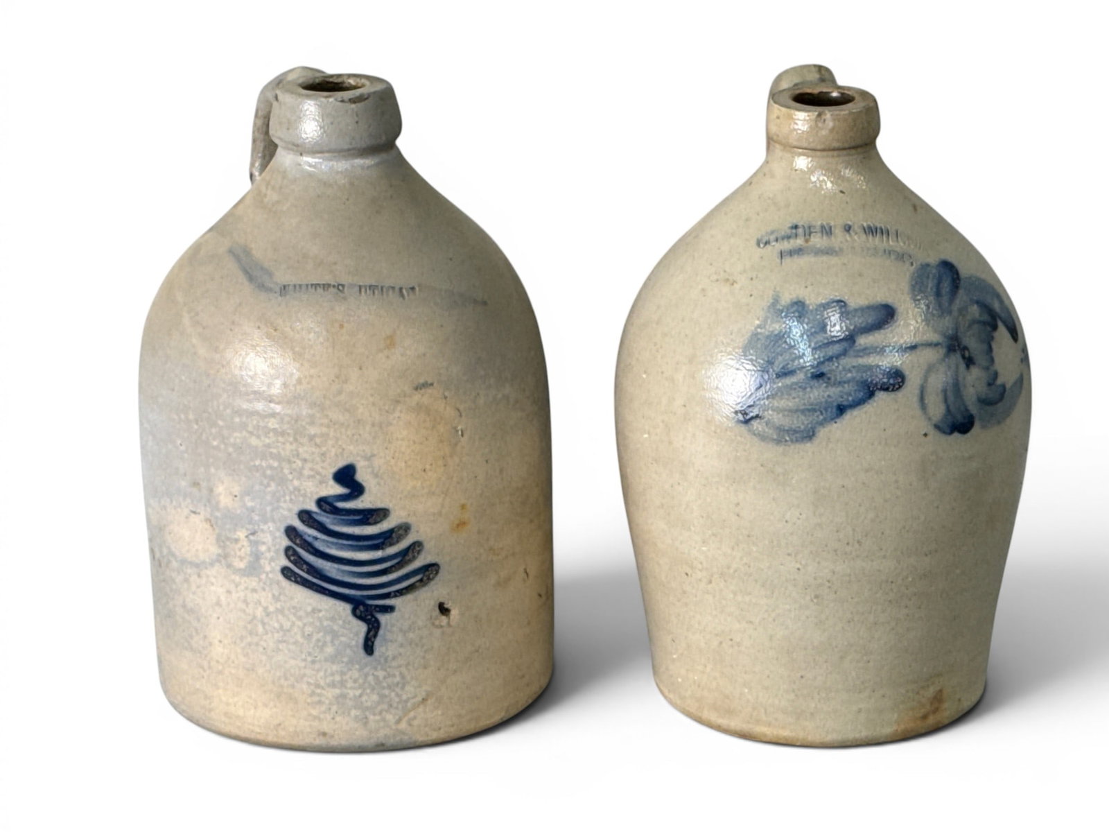 Two Blue-Touch Decorated Stoneware Jugs: Two cobalt blue-touch decorated stoneware jugs with floral and slip designs. Provenance: From a Main Line, PA private collection. Taller: 11-1/2in tall x 7-1/2in wide. | You have additional shipping