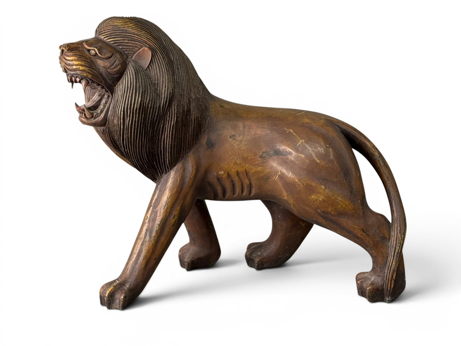 American Carved Walnut Figure of a Lion: An American Folk Art carved walnut figure of a lion, circa early 20th C. Provenance: From a Main Line, PA private collection. Ex. Allan Katz American, Connecticut. 22-1/2in tall x 32in wide x 12in