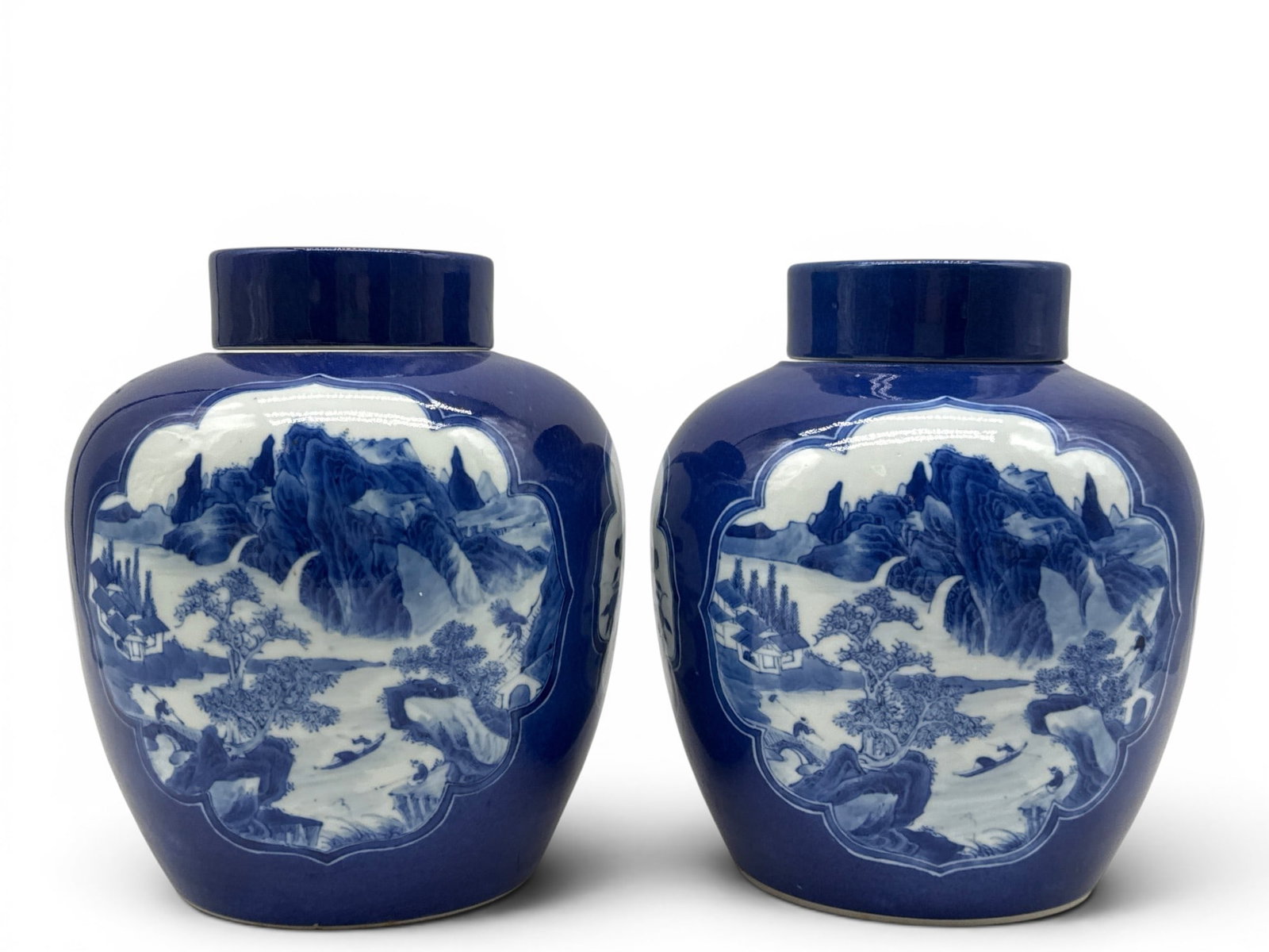 Pair of Chinese Powder Blue Porcelain Ginger Jars: A pair of Chinese porcelain powder blue covered ginger jars with landscape and vase panel designs, and six character marks. 9-1/2in tall x 7in wide. | You have additional shipping options, and are not