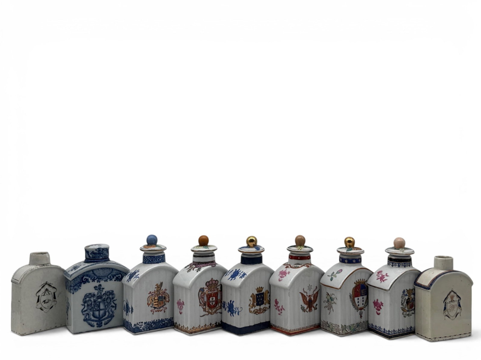 Nine Chinese Export-style Armorial Tea Caddies: Nine Chinese export porcelain tea caddies with gilt-decorated armorial crests and fruit-decorated lids. Contemporary and antique. 6-1/2in tall x 3in wide. | You have additional shipping options, and a