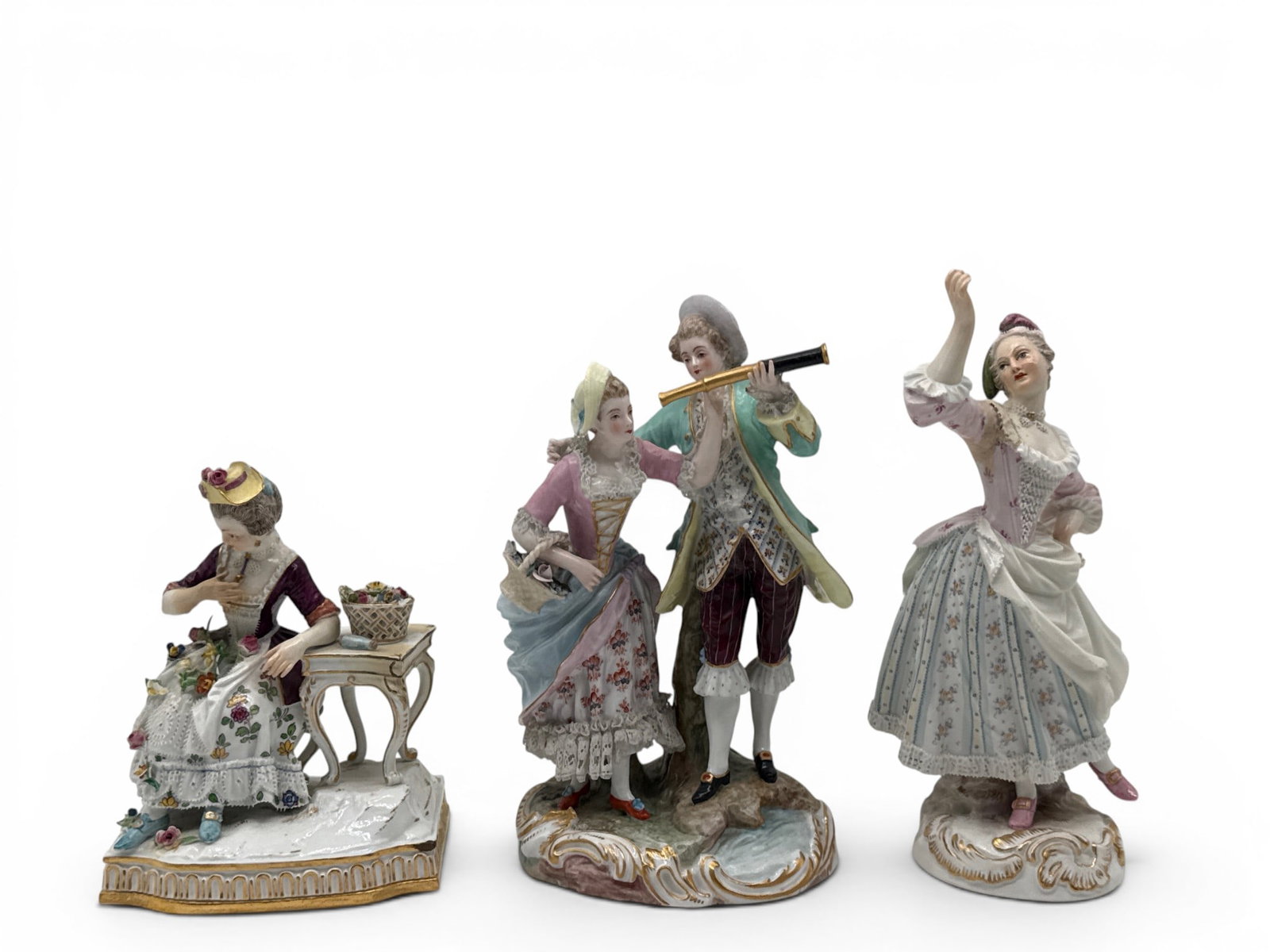 Three Meissen Porcelain Figurines: Three Meissen porcelain figurines to include a couple looking through telescope, a woman seated at a desk with flowers, and a dancing woman. Each with Meissen marks. 8in tall x 4in wide. | You have ad