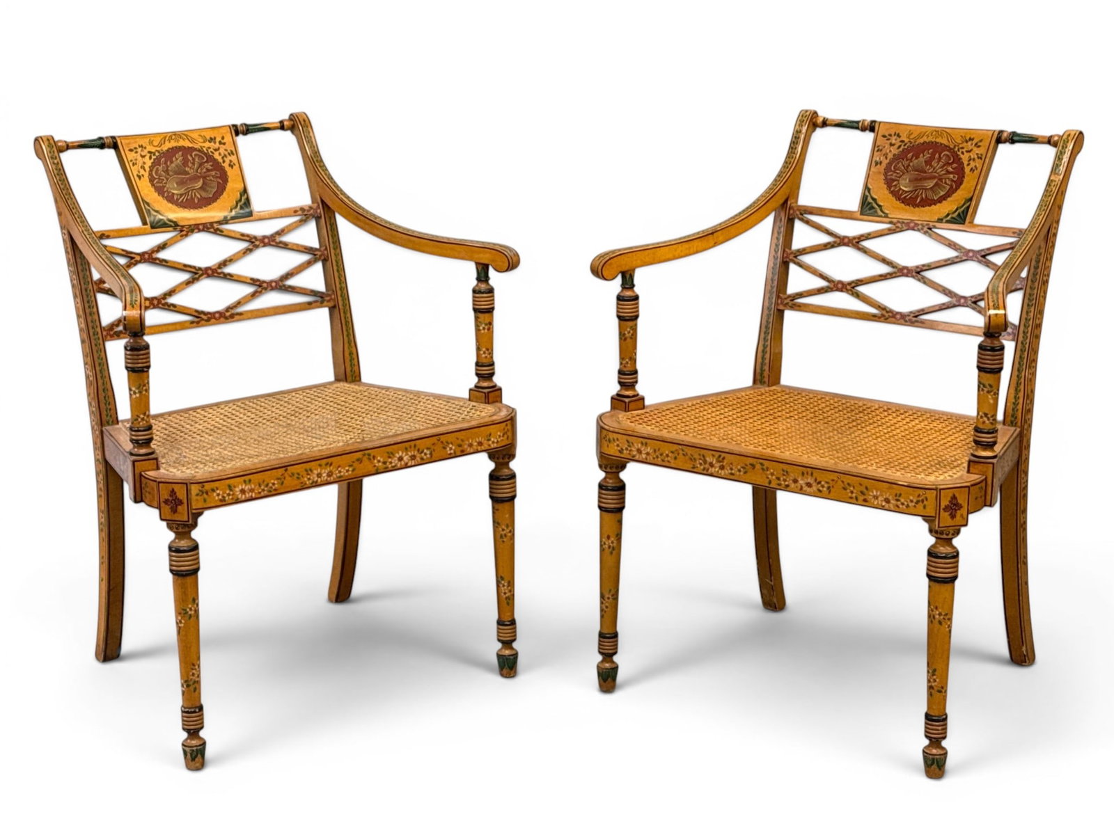 Pair of Adams-style Paint-Decorated Open Armchairs: A pair of Adams-style paint-decorated open armchairs with caned seats. 32in tall x 25in wide x 21in deep. | You have additional shipping options, and are not required to use Live Shipping. Additional 