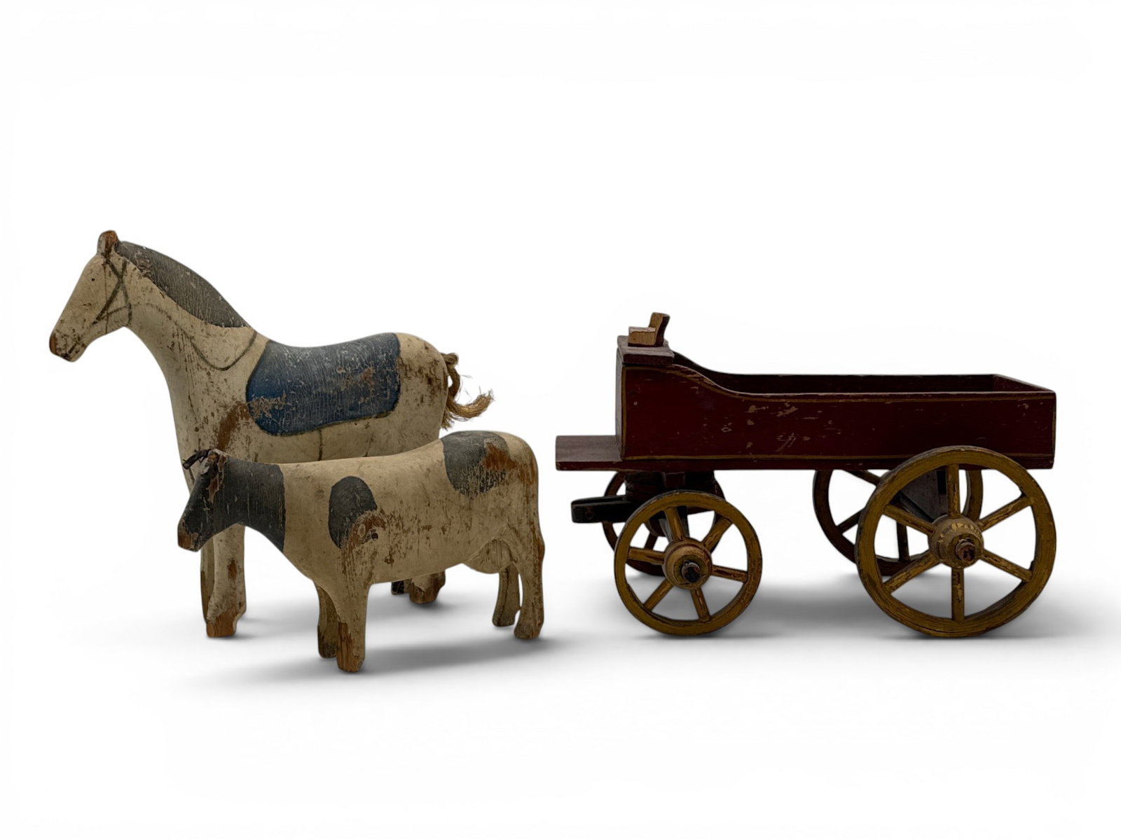 Folk Art Carved Horse, Cow, Wagon: A folk art carved and painted horse and cow, circa 19th C. and a wooden wagon. Provenance: From a Main Line, PA private collection. Horse and cow purchased from Walters and Benisek at the Philadelphia