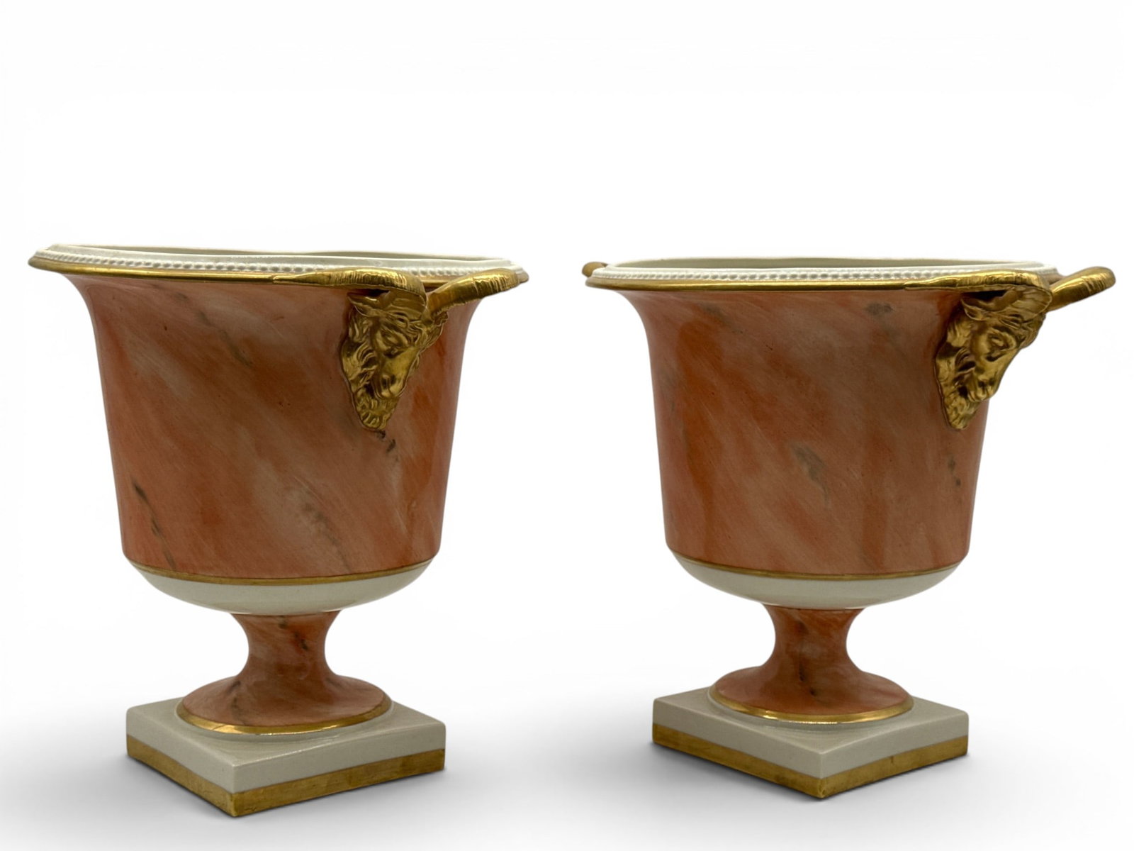 Pr. Italian Neoclassical-style Marbled Porcelain Urns: A pair of Italian Neoclassical-style porcelain urns with painted marbleized bodies and gilt-decorated ram's head handles. Marked Italy. 10in tall x 12in wide. | You have additional shipping options,