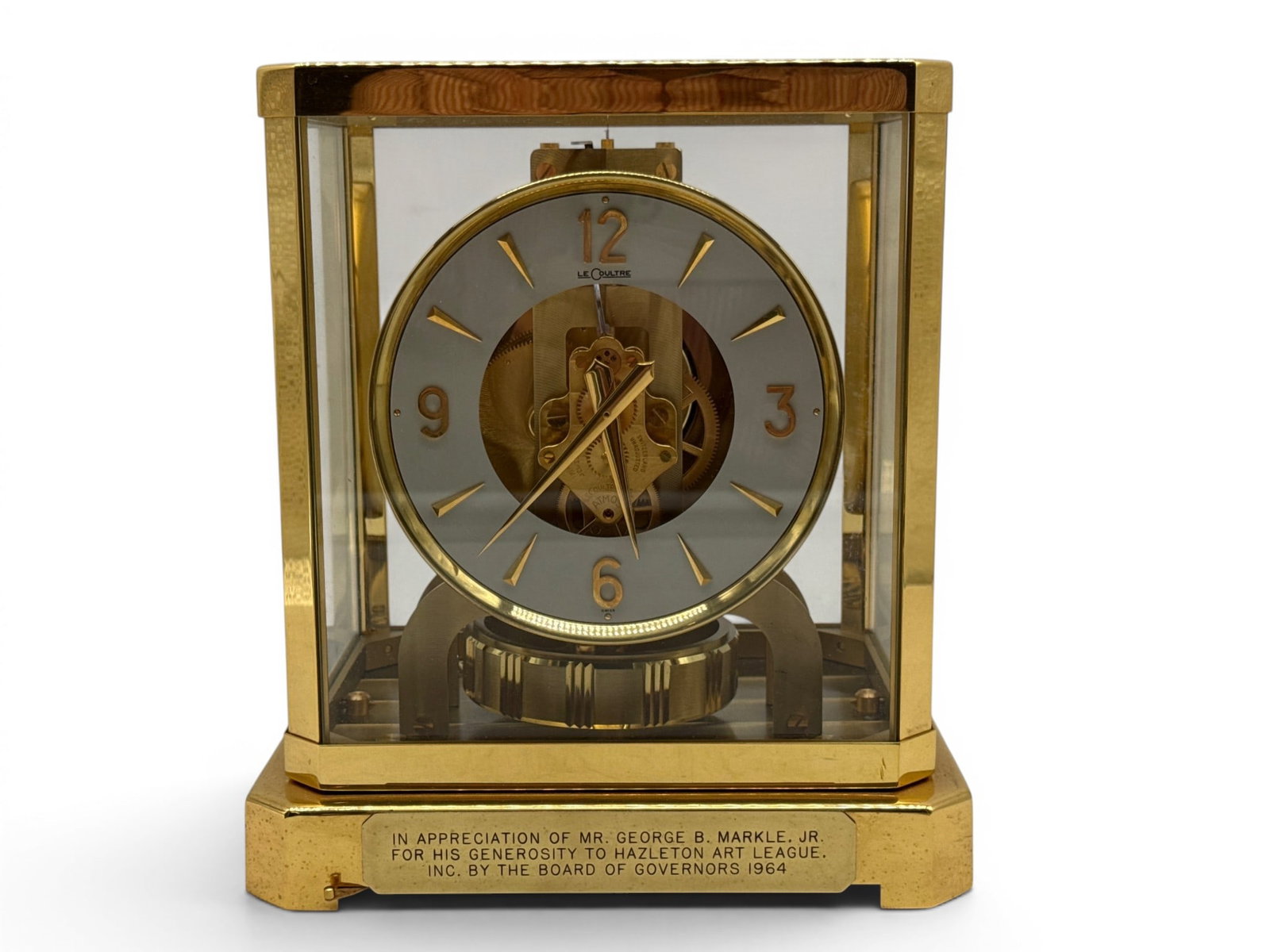 Le Coultre Atmos Clock: A Le Coultre perpetual-motion Atmos clock with brass case. Dedicated to Mr. George Markle in 1964. Marked Le Coultre et Cie verso. Includes original tag. 9-1/2in tall x 8in wide. | You have additional