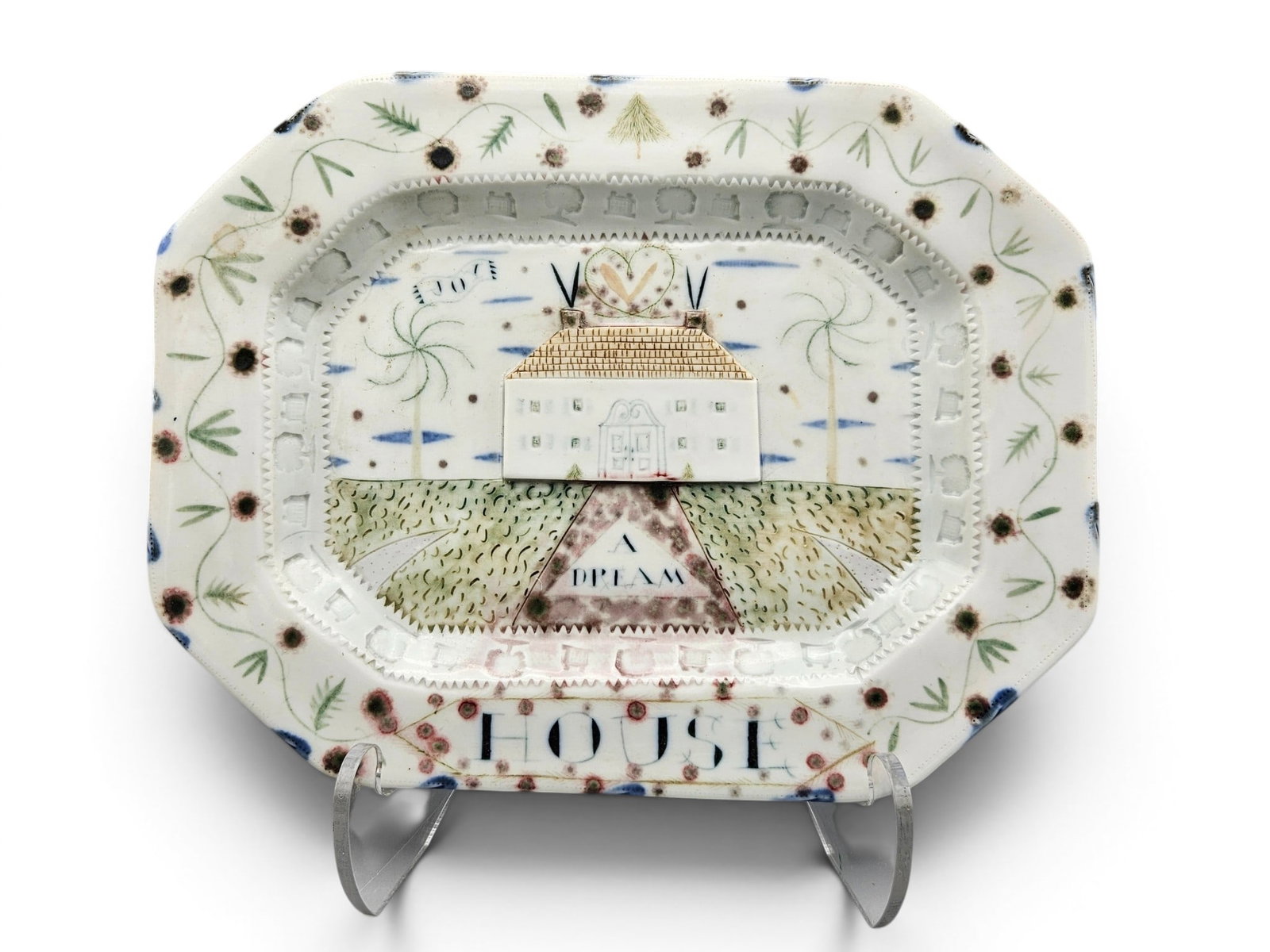 Mara Superior Porcelain Platter: A Dream House Platter: A Mara Superior glazed and underglazed porcelain platter titled "A Dream House" with quaint house at center surrounded by impressed hearts, trees and symbols with a painted floral border. | You have a