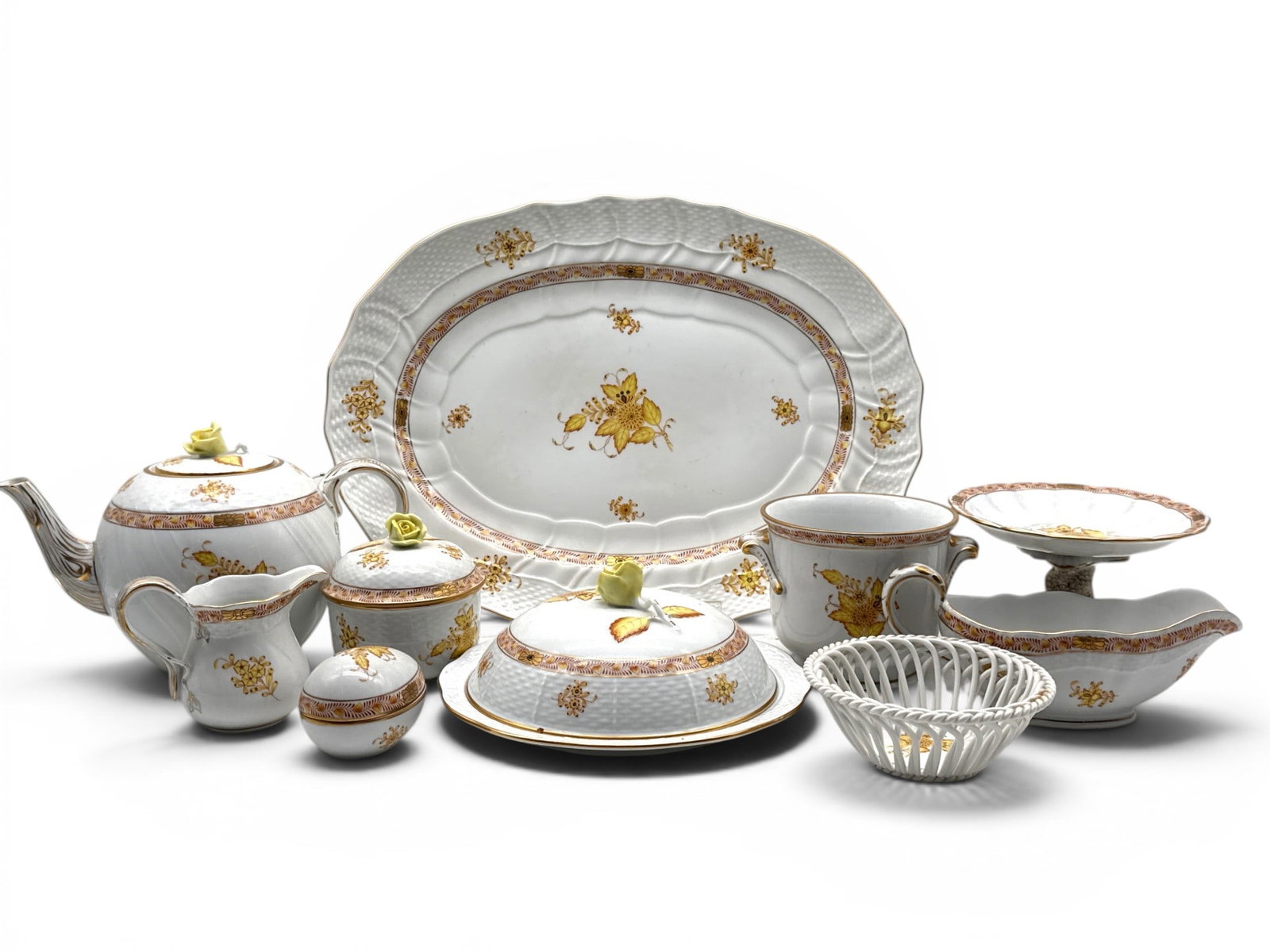 10 Pieces of Herend Chinese Bouquet Porcelain: Ten pieces of Herend of Hungary porcelain tablewares in the yellow Chinese Bouquet pattern to include a serving platter, a dolphin footed tazza, a waste bowl, a gravy boat, a reticulated bowl, a cover